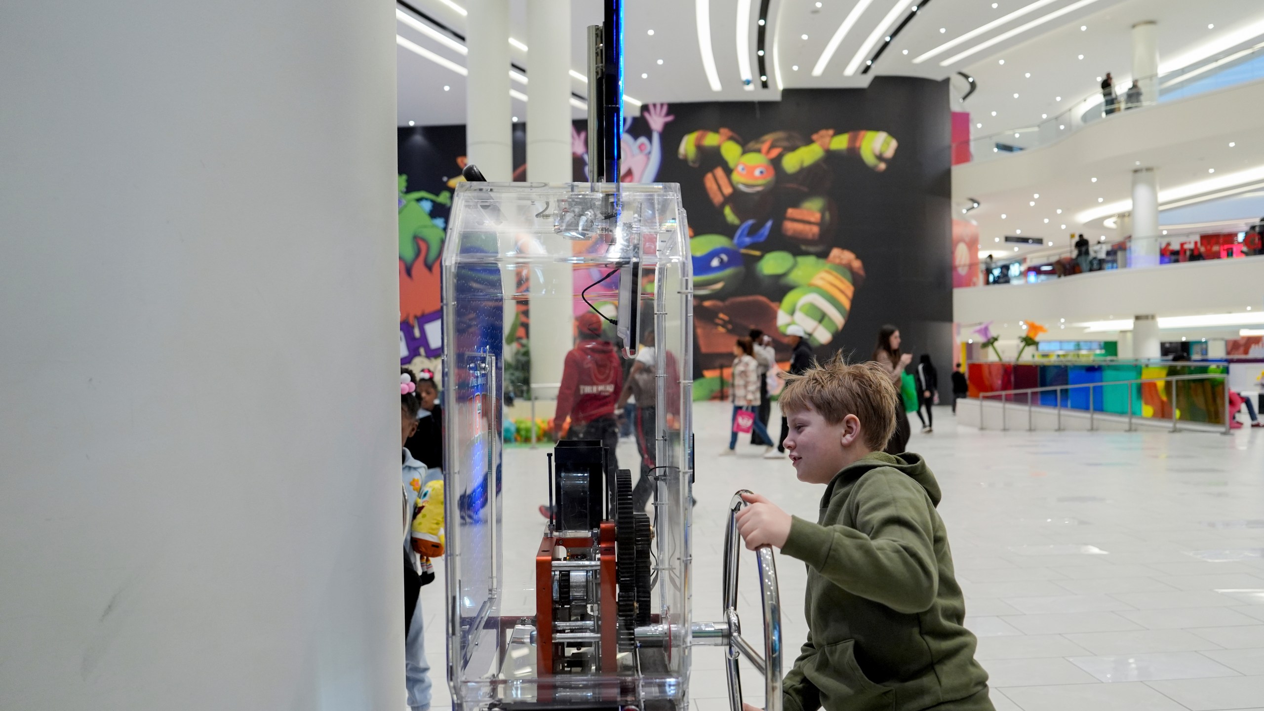 A child uses a penny press machine