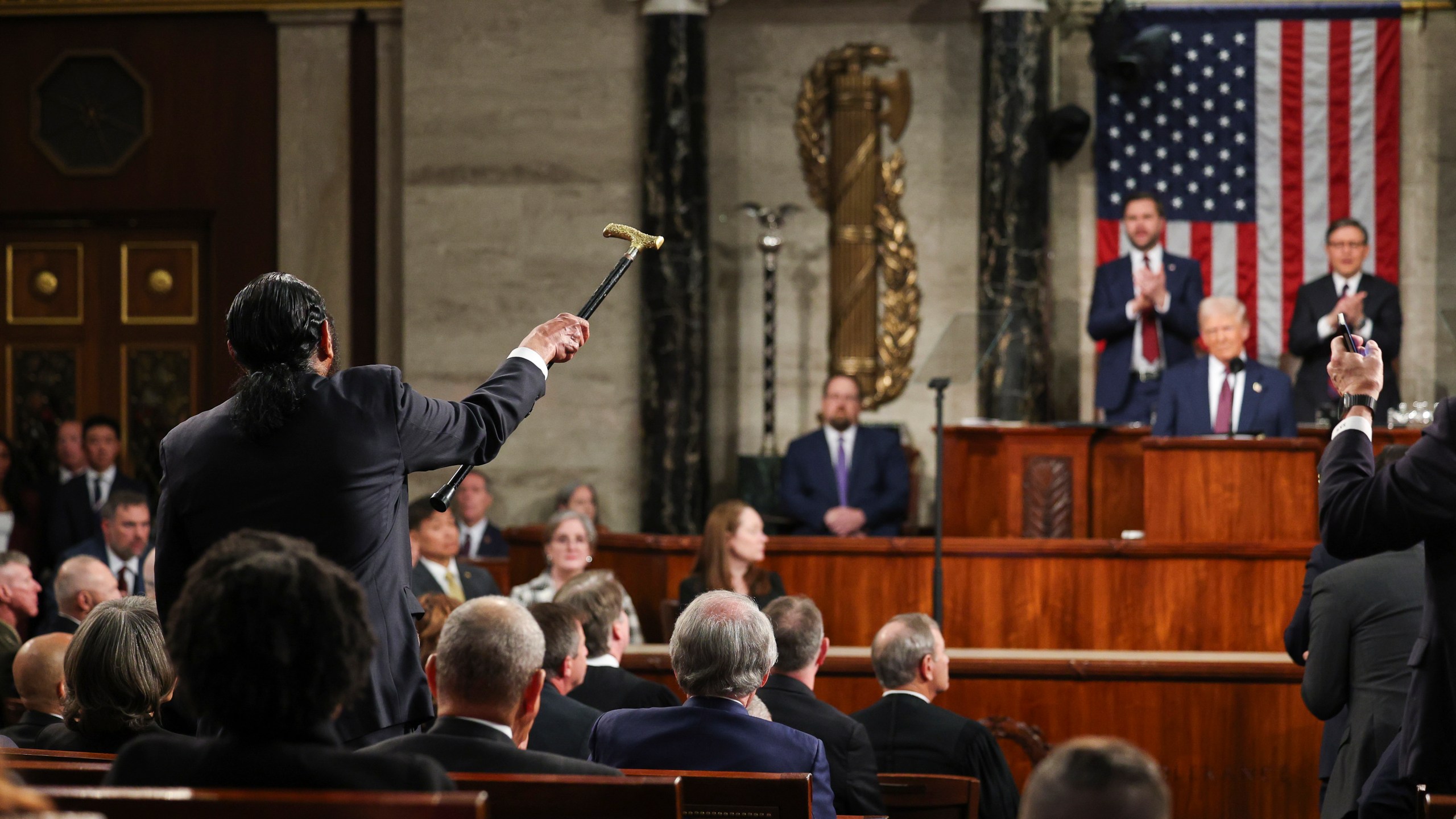 Rep. Al Green, D-Texas, left, shouts as President Donald Trump addresses a joint session of Congress at the Capitol in Washington, Tuesday, March 4, 2025. (Win McNamee/Pool Photo via AP)