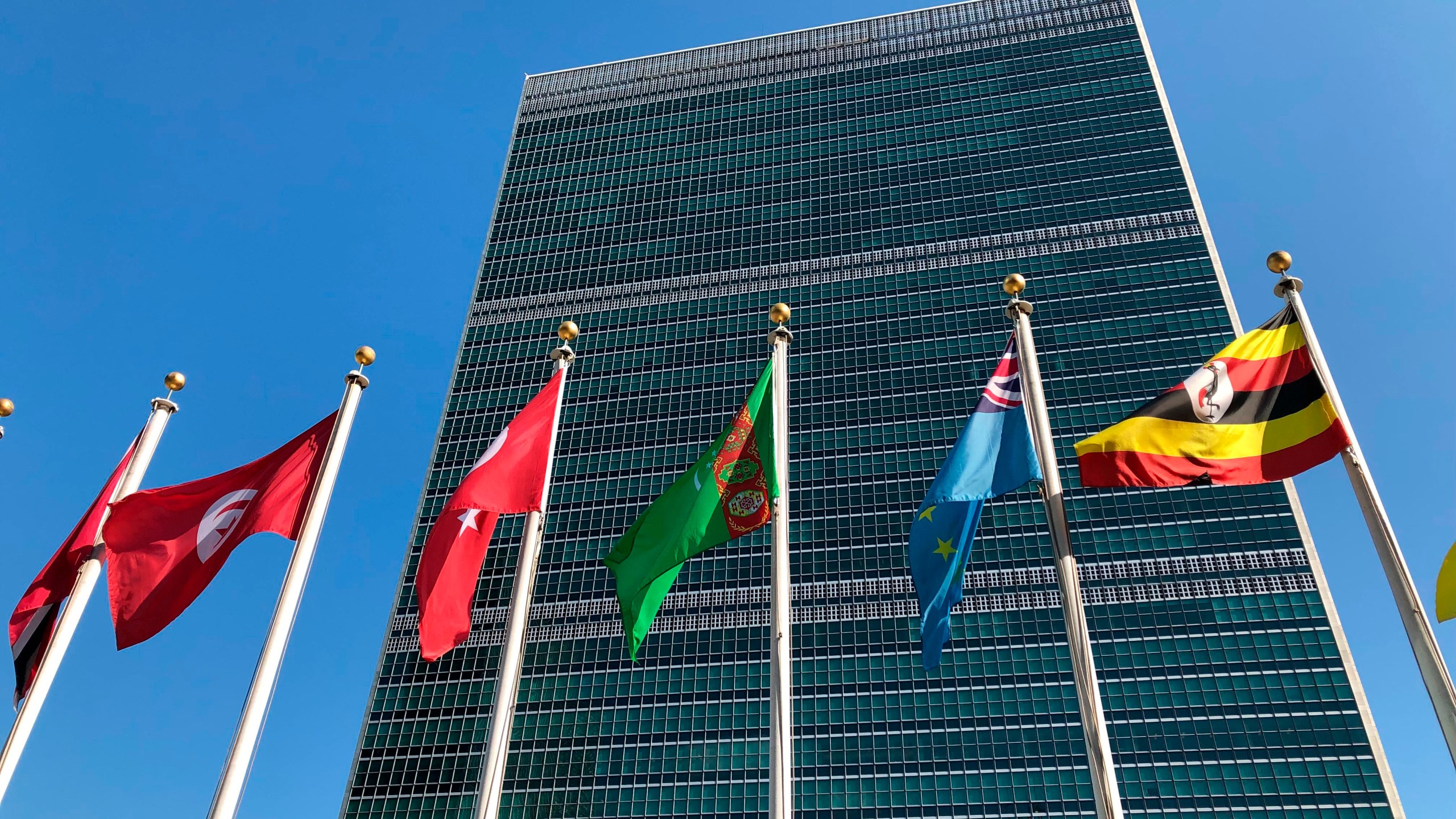 FILE - Flags fly outside the United Nations headquarters Sept. 28, 2019. (AP Photo/Jennifer Peltz, File)