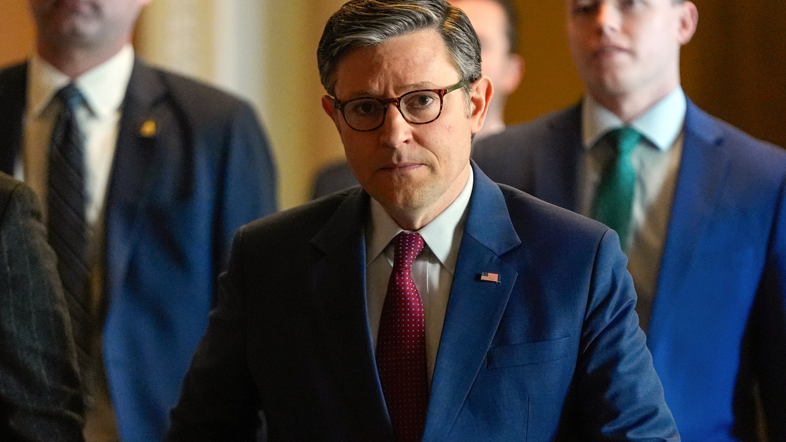 Mike Johnson walks through the Capitol