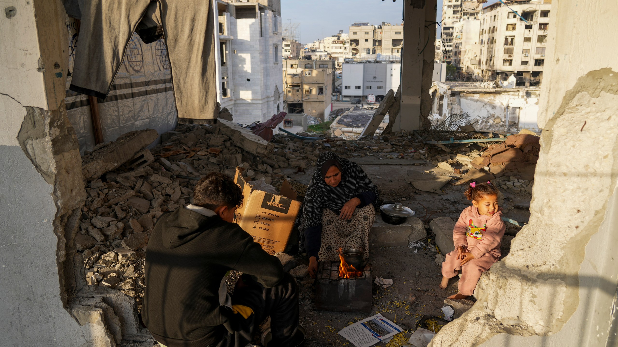 Displaced Palestinians make tea at a school run by UNRWA, the U.N. agency helping Palestinian refugees, west of Gaza City, Sunday, March 9, 2025. (AP Photo/Jehad Alshrafi)