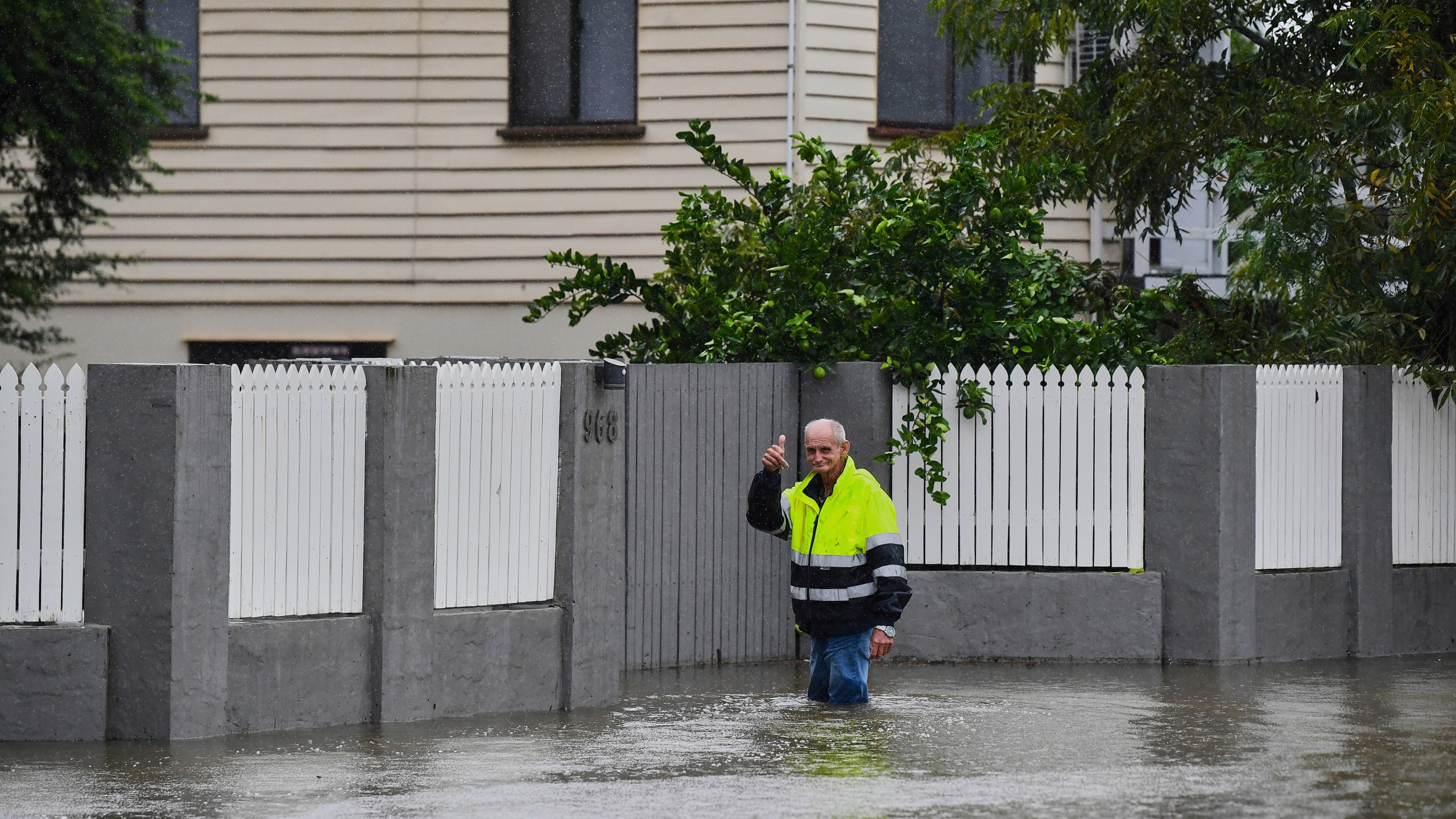 Resident Bruce Maddox walks back through flood waters to his home in the Brisbane suburb of Oxley, Australia, Monday, March 10, 2025. (Jono Searle/AAP Image via AP)