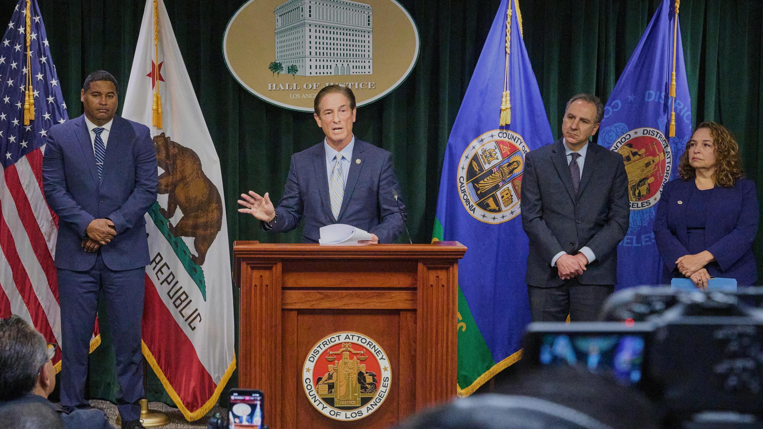 Los Angeles County District Attorney Nathan Hochman is surrounded by law enforcement officials as he gives a news conference about the Menendez brothers case in Los Angeles, Monday, March 10, 2025. (AP Photo/Damian Dovarganes)