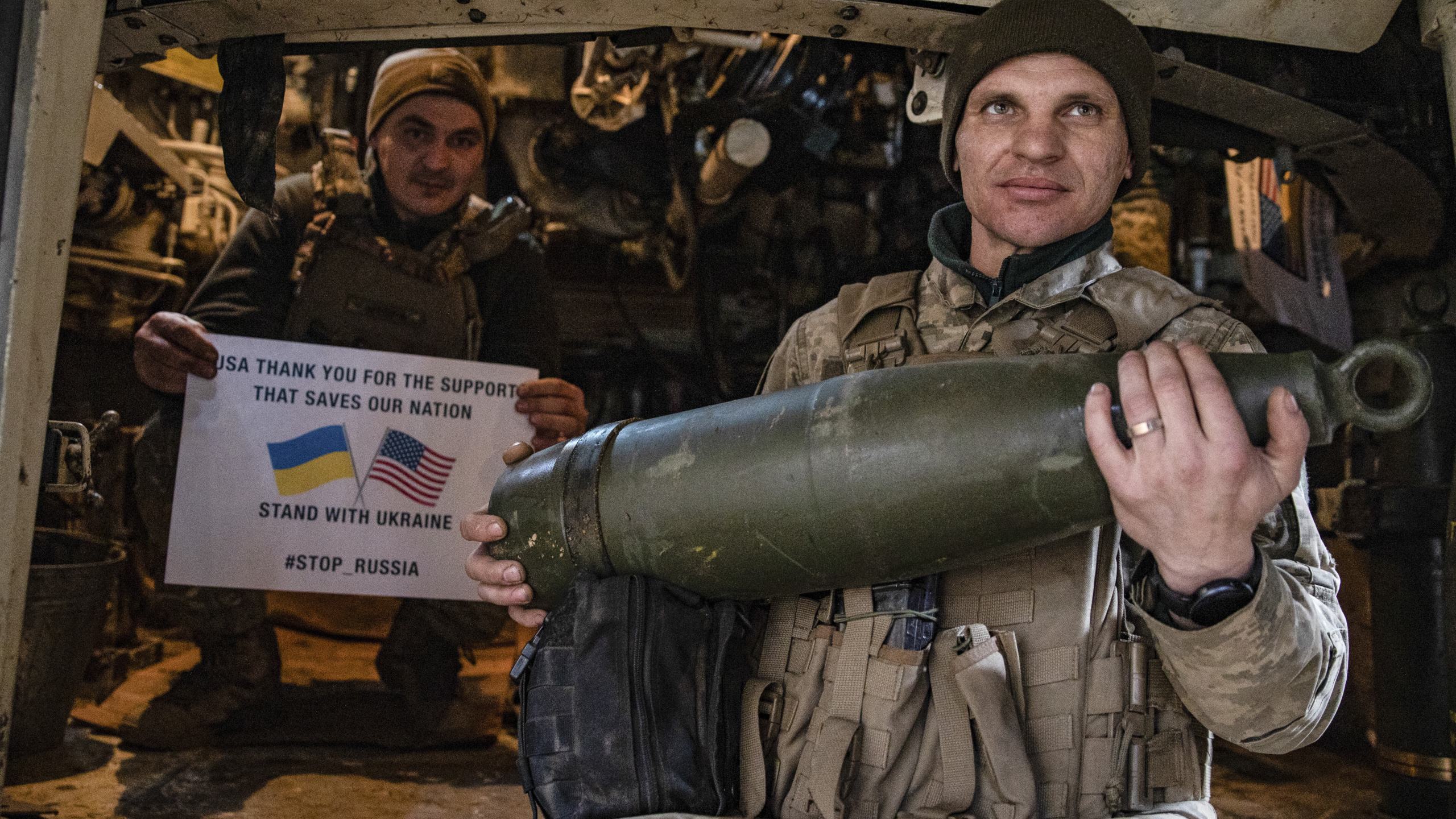 Soldiers of Ukraine's 5th brigade hold a poster thanking for the US for support during a flashmob at the front line near Toretsk, Donetsk region, Ukraine, Tuesday, March 11, 2025. (AP Photo/Roman Chop)