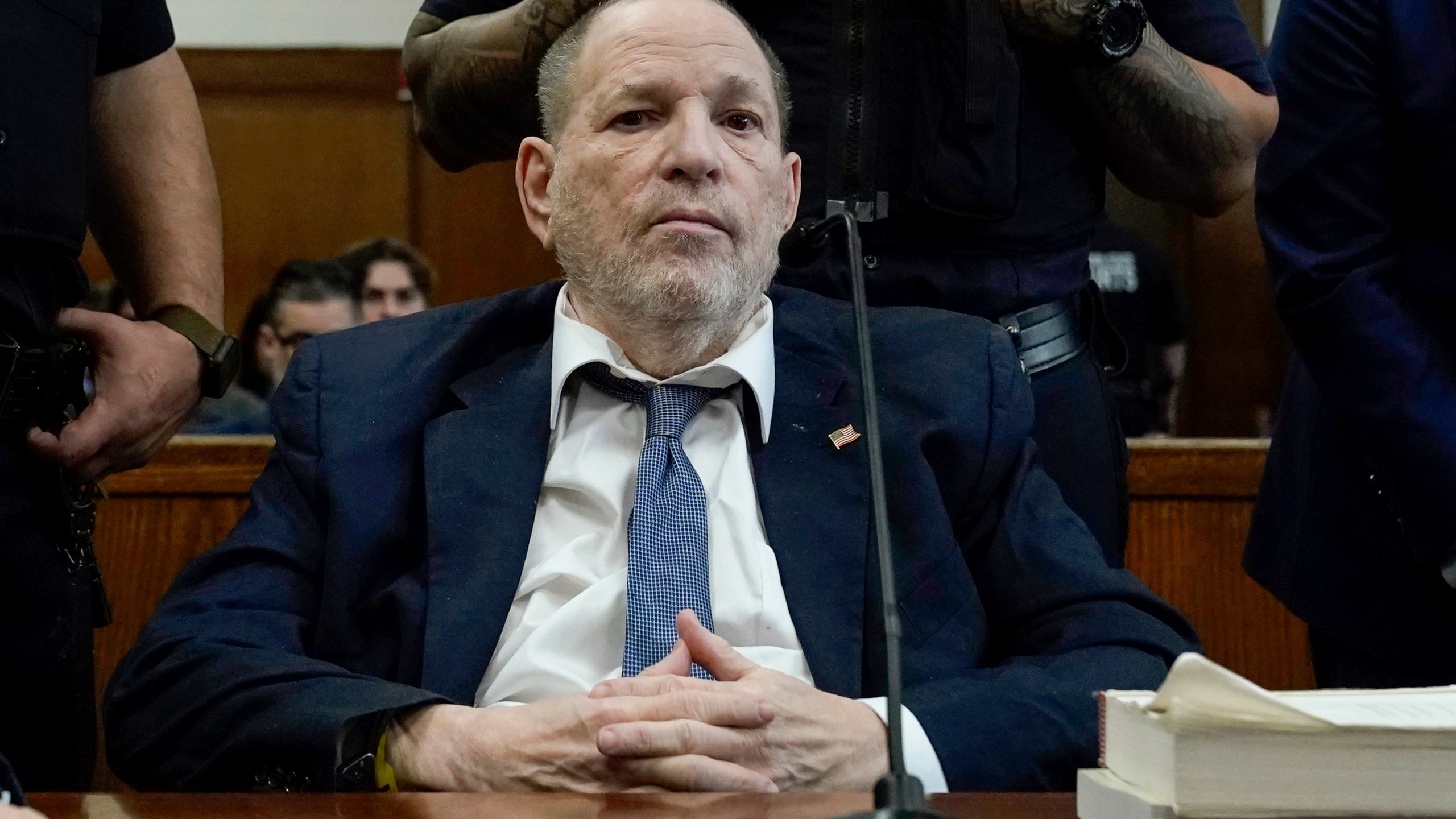 Harvey Weinstein sits in a courtroom
