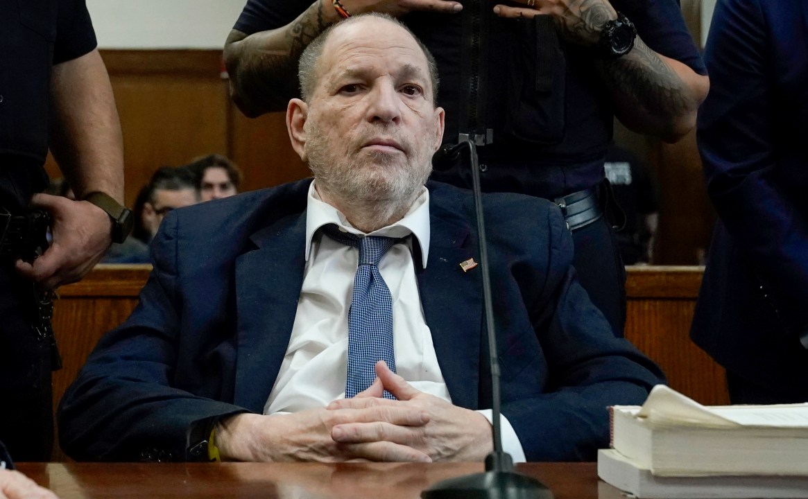 Harvey Weinstein sits in a courtroom
