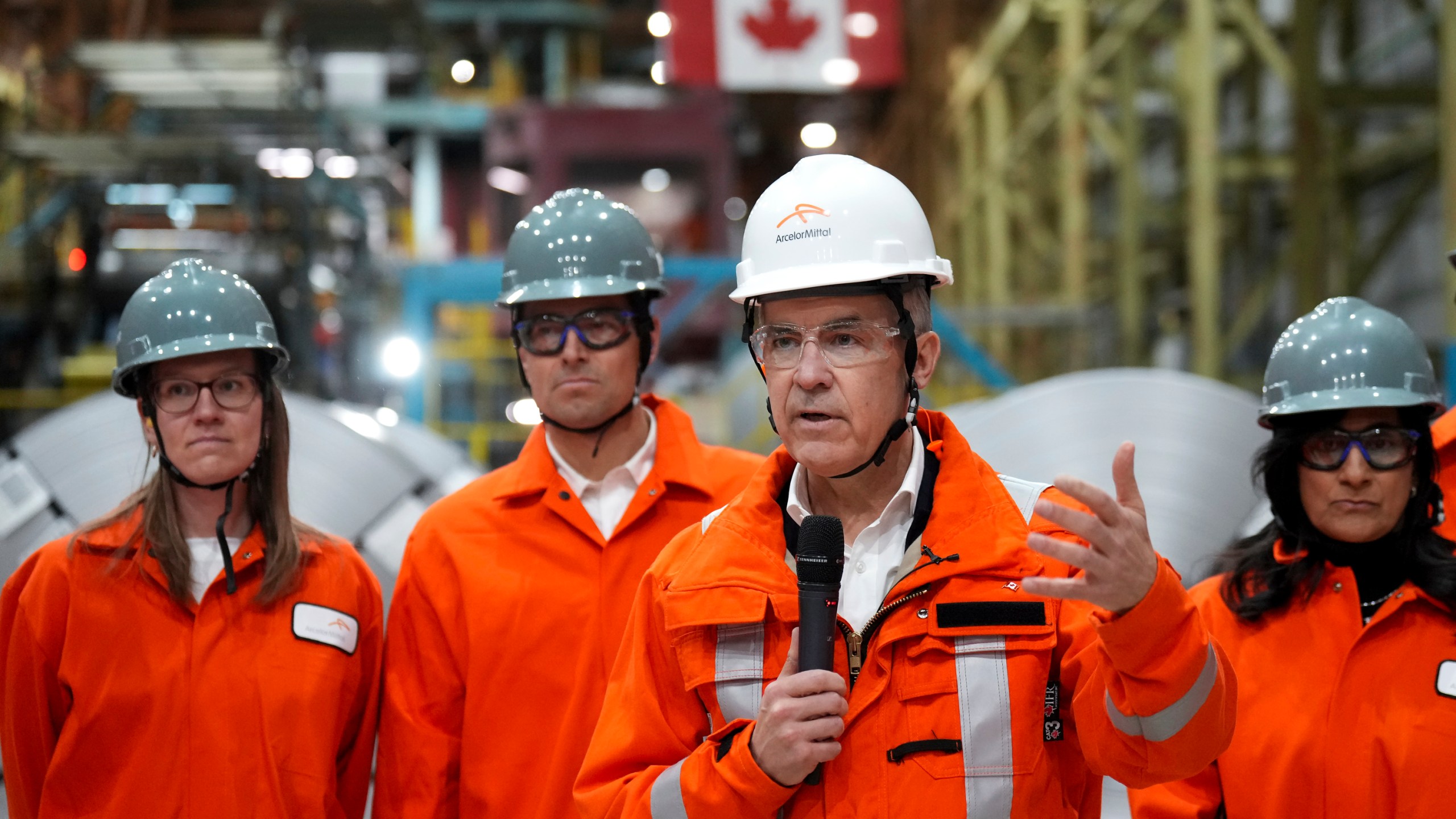 Canadian Prime Minister designate Mark Carney, second right, speaks to steel workers after touring the ArcelorMittal Dofasco steel plant in Hamilton, Ont., on Wednesday, March 12, 2025. (Nathan Denette /The Canadian Press via AP)