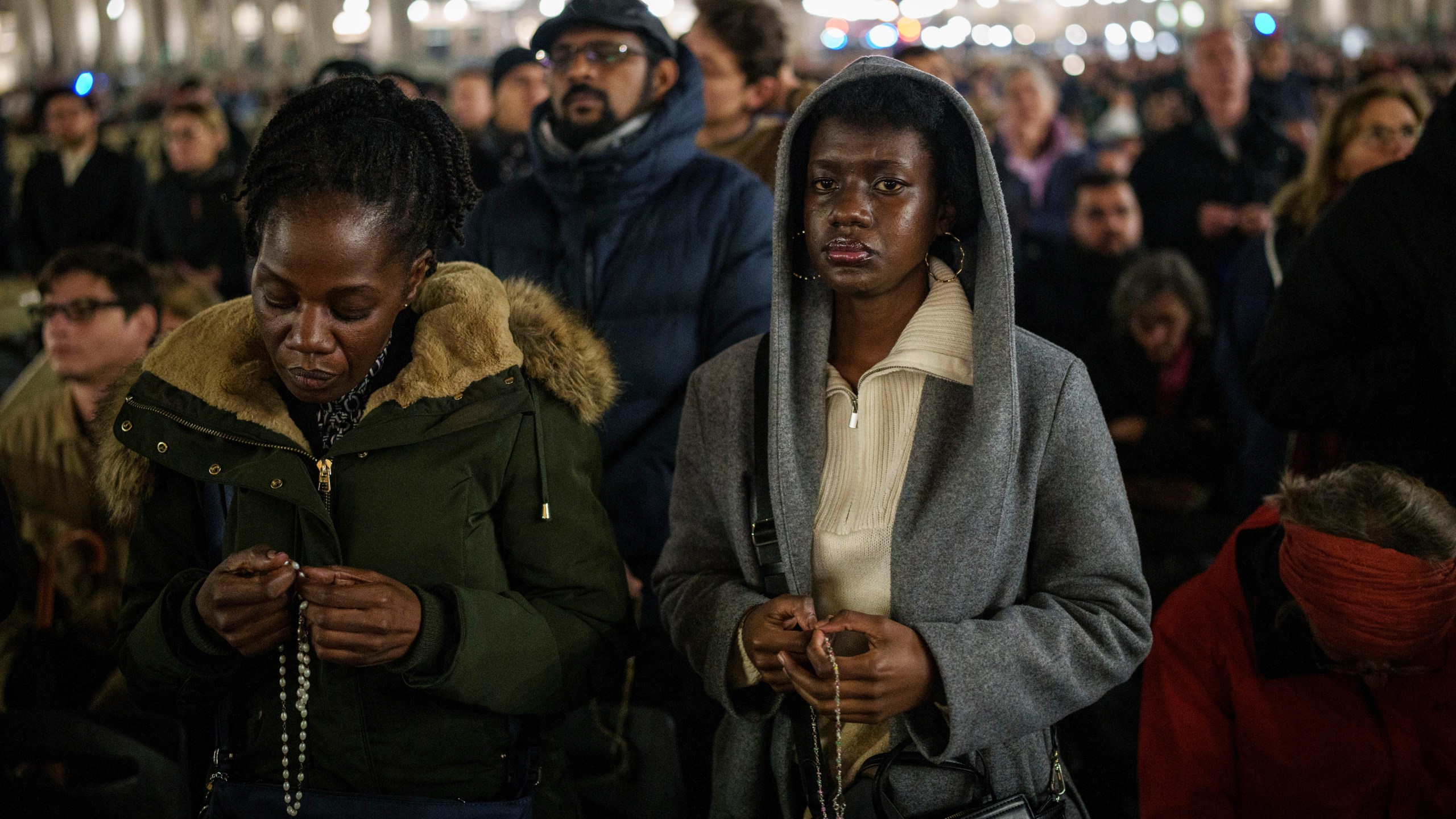 Catholic worshippers gather to pray the rosary for Pope Francis' health in St. Peter's Square at The Vatican, Monday, Feb. 24, 2025. (AP Photo/Bernat Armangue)