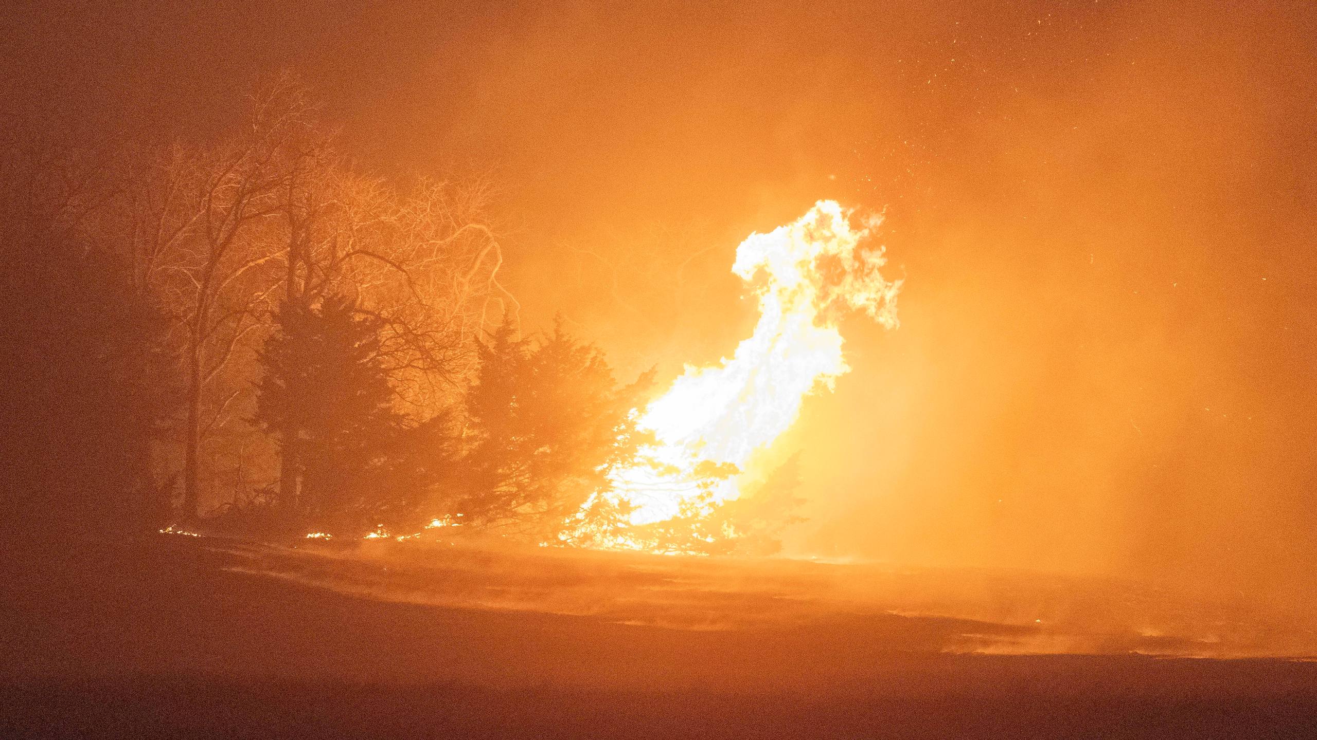 A wildfire burns at night on Friday, March 14, 2025, south of Langston, Okla. (AP Photo/Alonzo Adams)