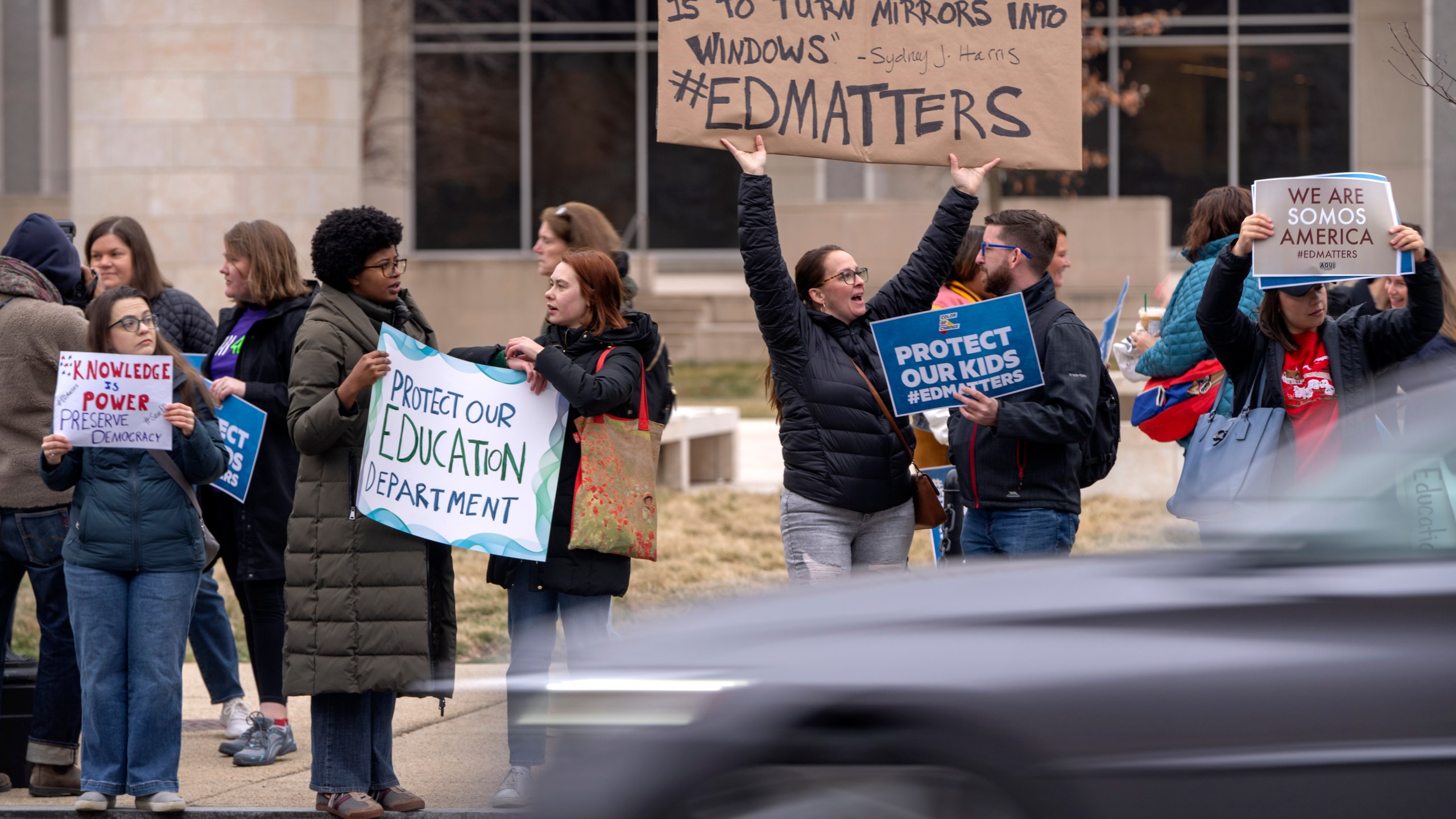 Protestors gather during a demonstration at the headquarters of the Department of Education.