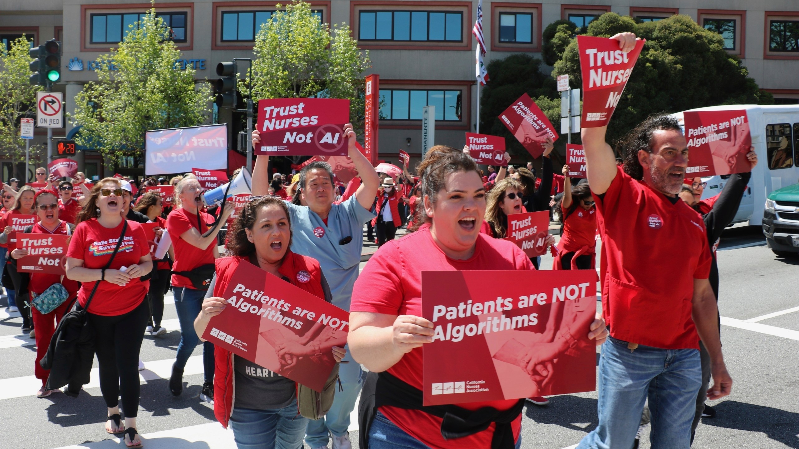 In this photo provided by National Nurses United, nurses hold a rally in San Francisco on April 22, 2024, to highlight safety concerns about using artificial intelligence in health care. (National Nurses United via AP)