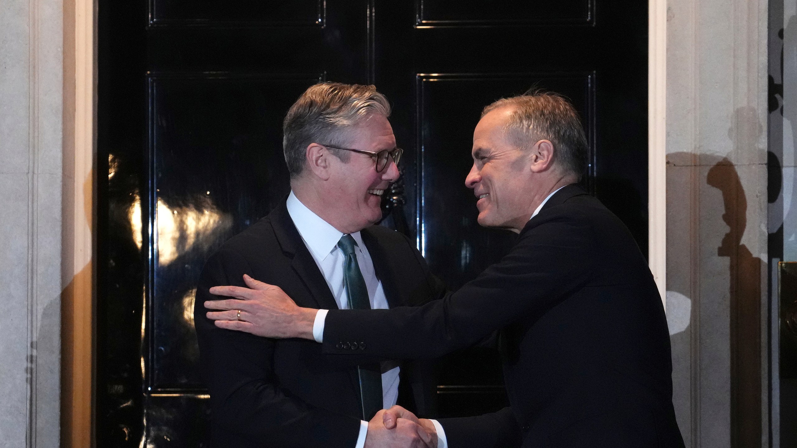 Canada Prime Minister Mark Carney is greeted by British Prime Minister Keir Starmer as he arrives in London on Monday, March 17, 2025. (Sean Kilpatrick/The Canadian Press via AP)