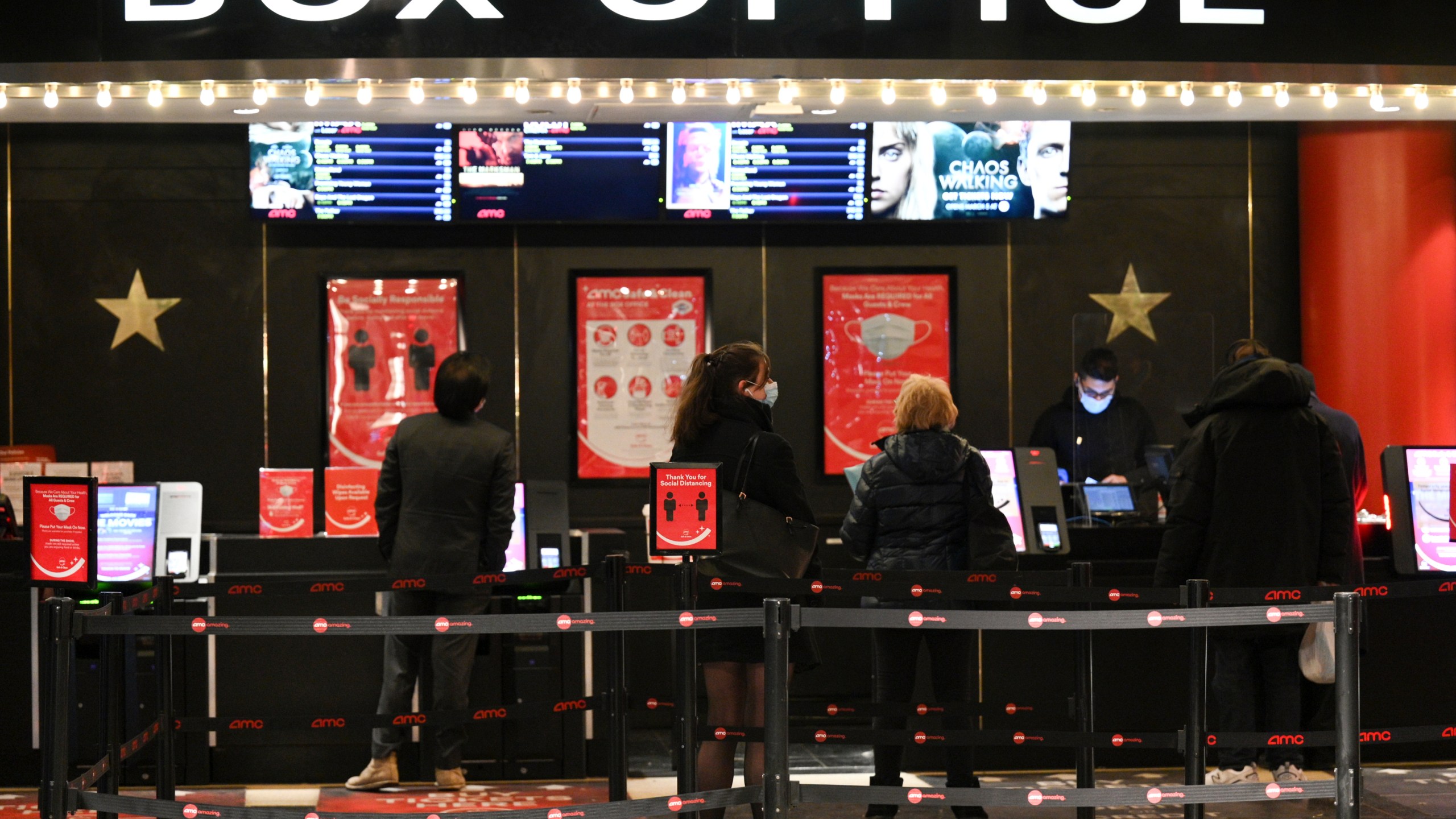 FILE - People purchase tickets at a movie theater in New York on March 5, 2021. (Photo by Evan Agostini/Invision/AP, File)