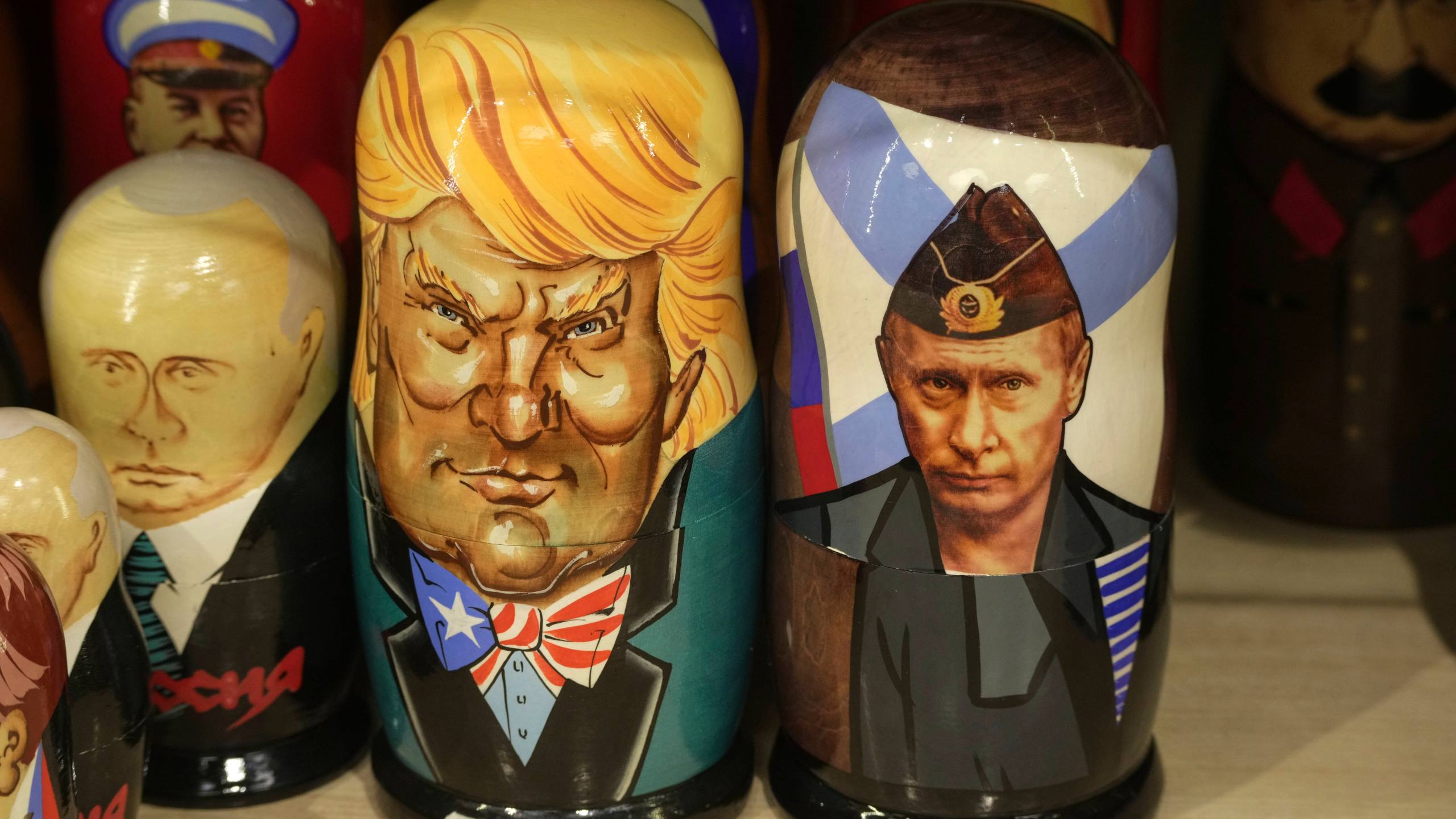 Traditional Russian wooden dolls called Matryoshka depicting Russian President Vladimir Putin, right, and US President Donald Trump are displayed for sale among others at a souvenir shop in St. Petersburg, Russia, Tuesday, March 18, 2025. (AP Photo/Dmitri Lovetsky)