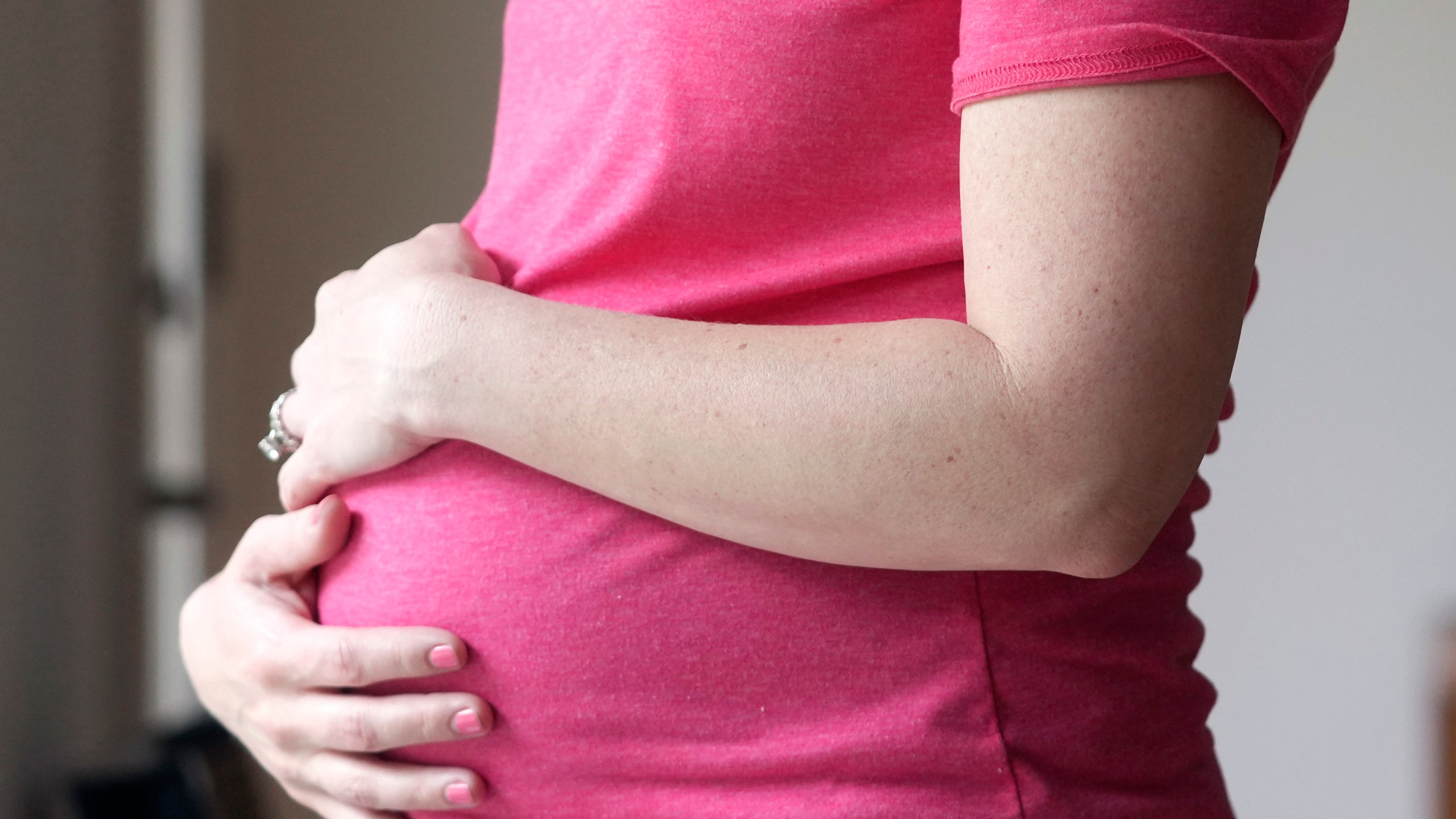 FILE - A pregnant woman stands for a portrait in Dallas, Thursday, May 18, 2023. (AP Photo/LM Otero, File)