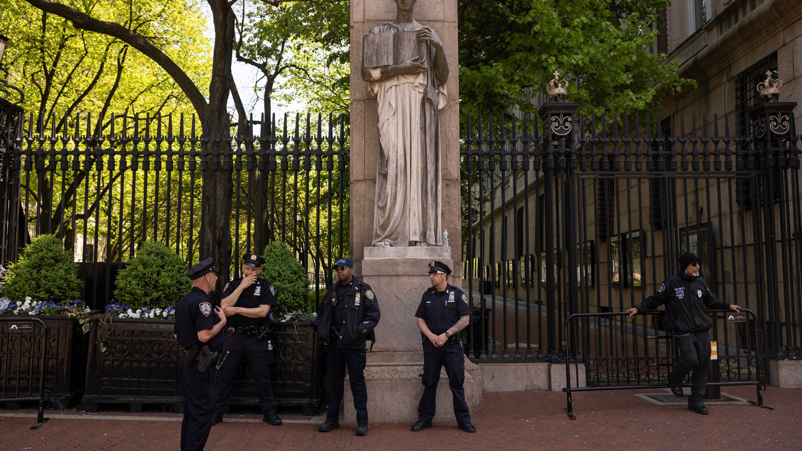 FILE - Police officers stand guard outside Columbia University, Thursday, May 2, 2024, in New York. (AP Photo/Yuki Iwamura, File)