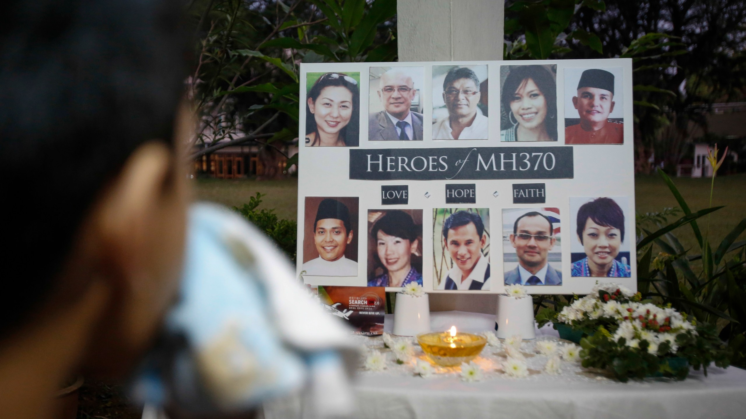 FILE - A Malaysian boy wipes his tears during a special prayer for the ill fated Malaysia Airlines Flight 370 at a church in Kuala Lumpur, Malaysia, Tuesday, March 8, 2016. (AP Photo/Joshua Paul,File)