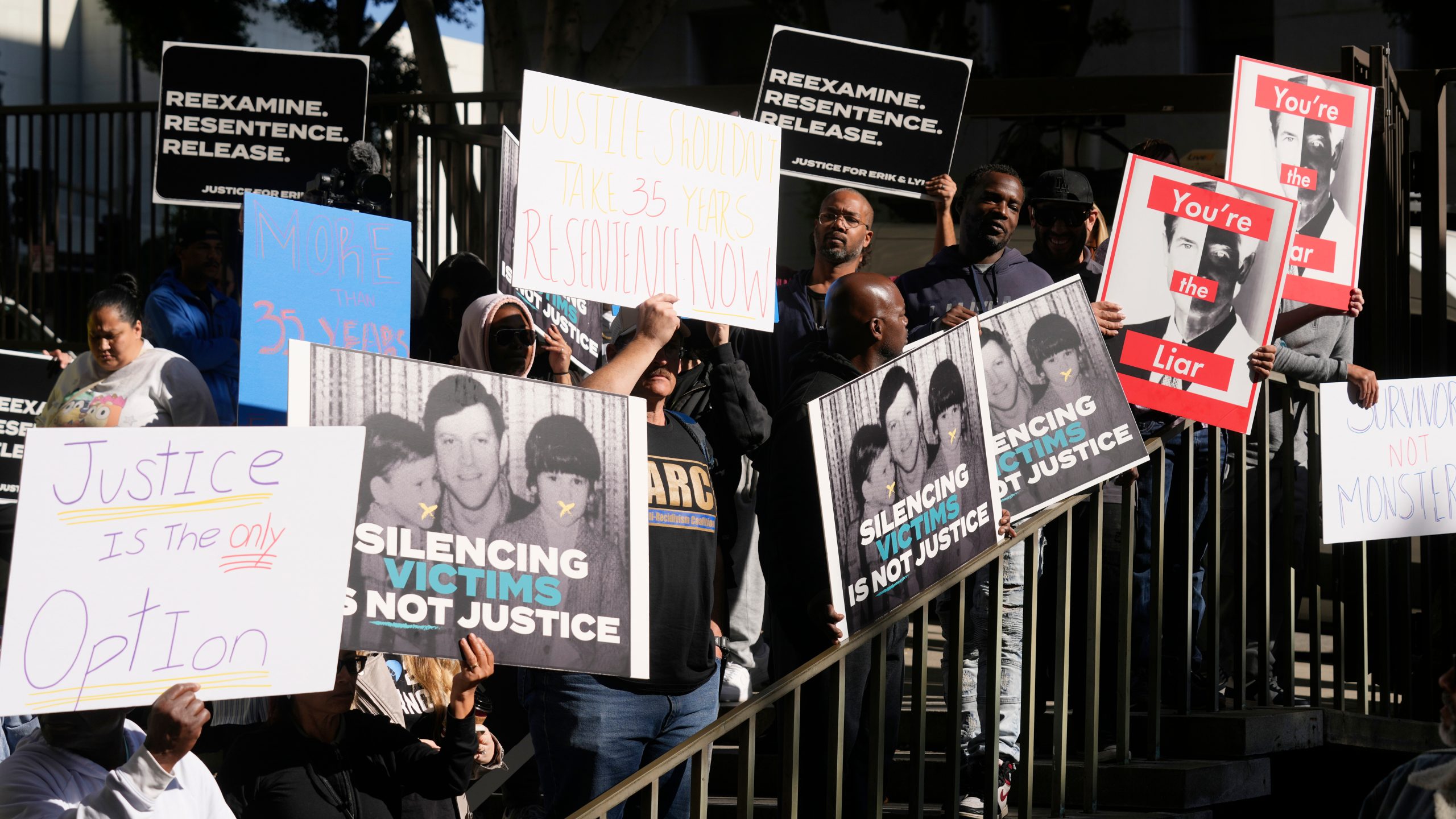 Supporters hold signs during a press conference regarding developments in the Menendez brothers case Thursday, March 20, 2025, in Los Angeles. (AP Photo/Damian Dovarganes)
