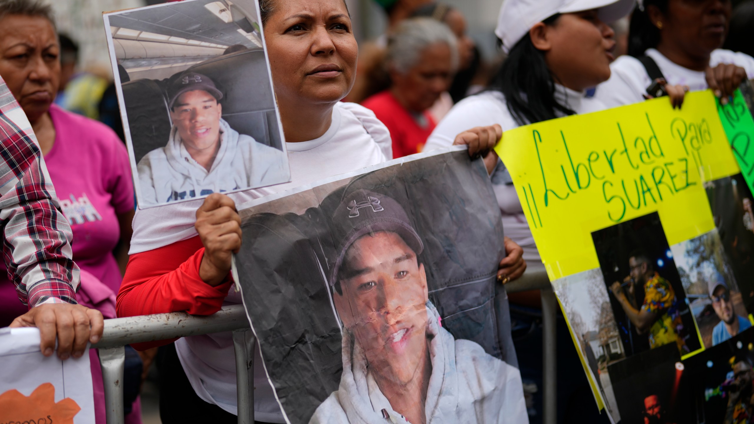Jasmin Ramirez holds a photo of her son, Angelo Escalona, at a government-organized rally protesting the deportation of alleged members of the Venezuelan Tren de Aragua gang, who were transferred to an El Salvador prison, in Caracas, Venezuela, Tuesday, March 18, 2025. Ramirez said she hadn't heard from her son since he called to say he was with a group of migrants about to be deported on March 14. (AP Photo/Ariana Cubillos)