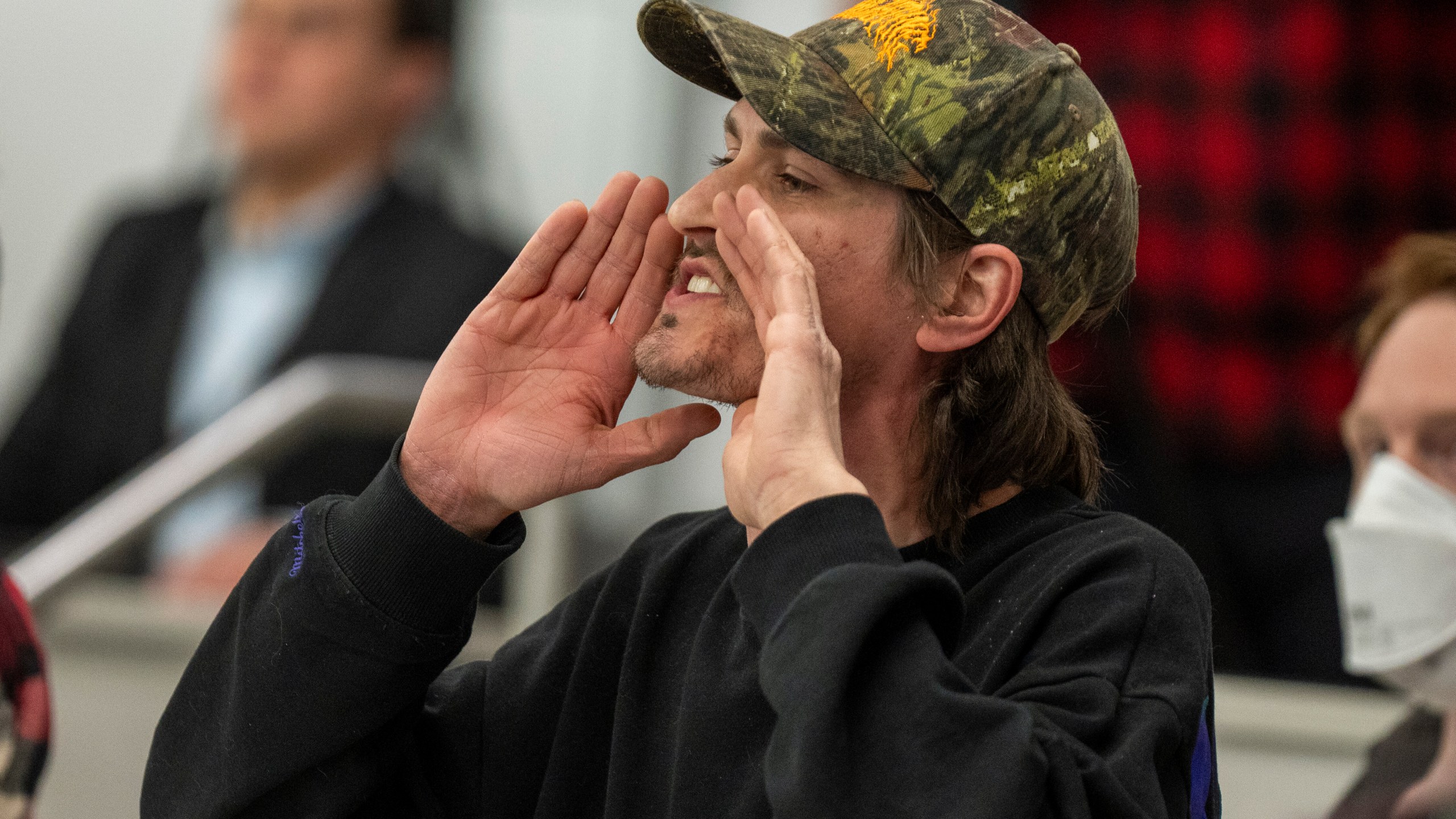 Owen Brings shouts a question to Reps. Celeste Maloy and Mike Kennedy, R-Utah, during a GOP town hall meeting Thursday, March 20, 2025, in Salt Lake City. (AP Photo/Rick Egan)