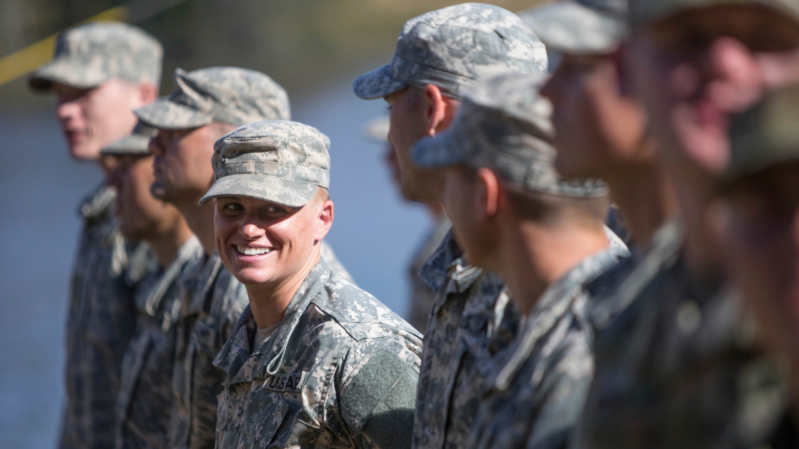 FILE - Maj. Lisa Jaster, center, the first Army Reserve female to graduate the Army's Ranger School, stands in formation with other Rangers during an Army Ranger school graduation ceremony, Oct. 16, 2015, in Fort Benning, Ga. (AP Photo/Branden Camp, File)