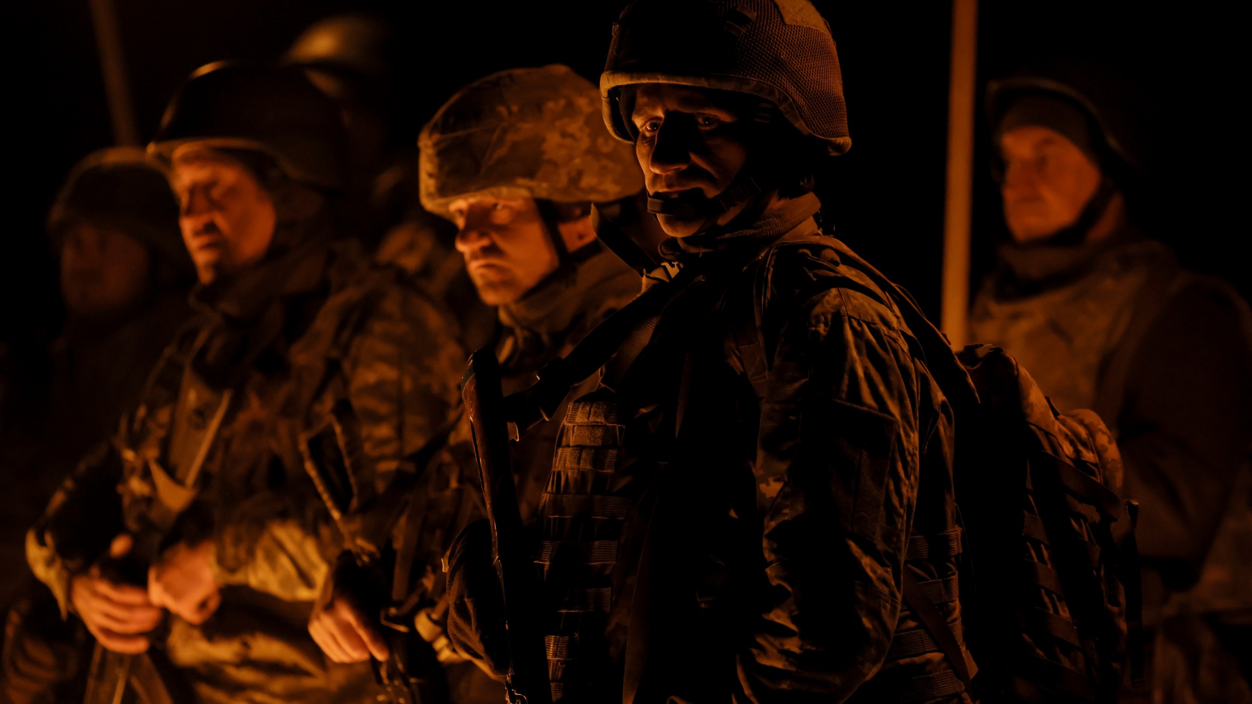 In this photo taken on March 21, 2025 and provided by Ukraine's 24th Mechanized Brigade press service on March 24, 2025, servicemen attend a dedication ceremony for soldiers near the frontline in the Donetsk region, Ukraine. (Oleg Petrasiuk/Ukraine's 24th Mechanized Brigade via AP)