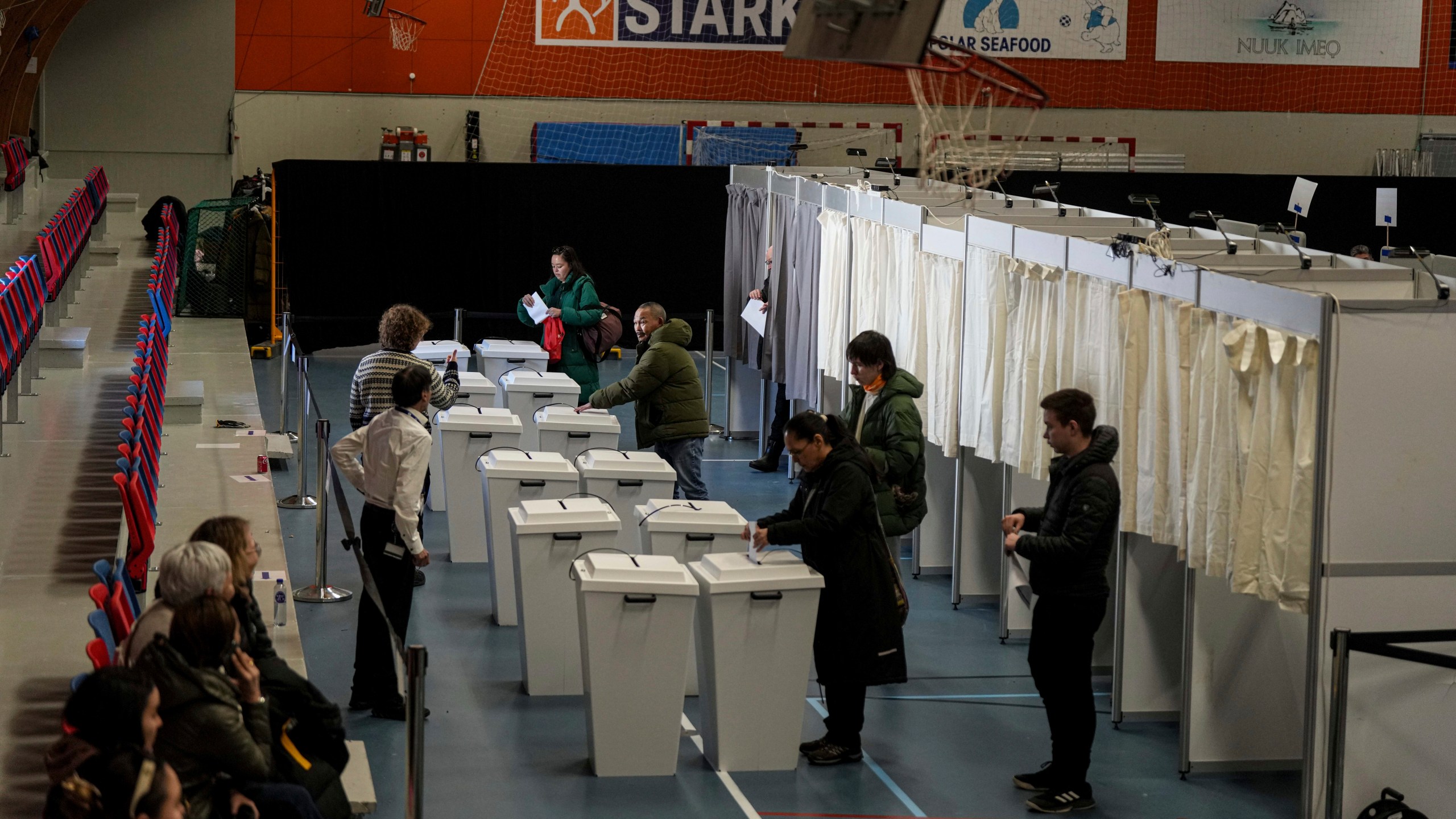 People cast their votes in parliamentary elections in Nuuk, Greenland, Tuesday, March 11, 2025. (AP Photo/Evgeniy Maloletka)