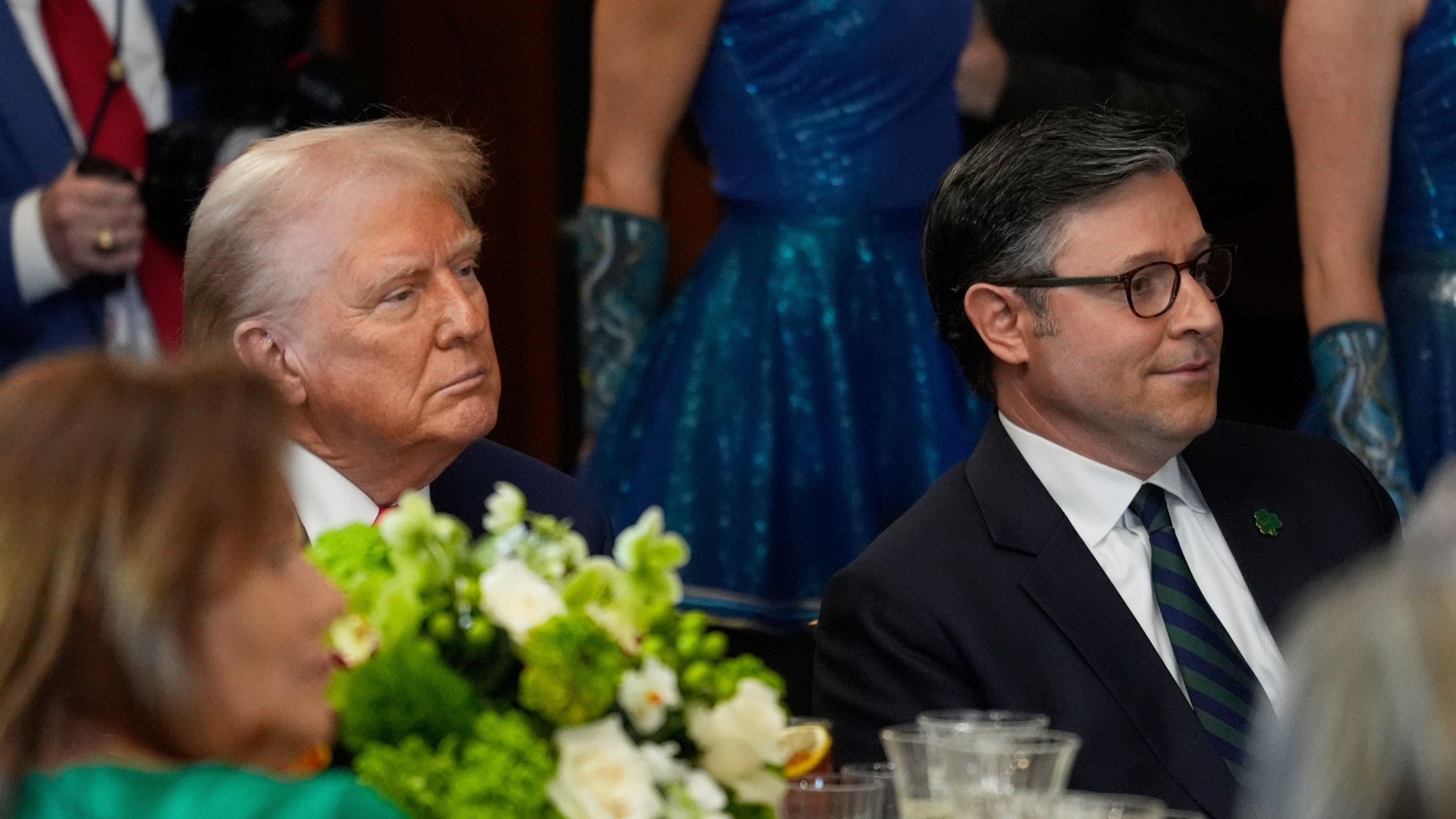 President Donald Trump and House Speaker Mike Johnson of La., listen at the annual St. Patrick's Day luncheon at the Capitol in Washington, Wednesday, March 12, 2025. (AP Photo/J. Scott Applewhite)