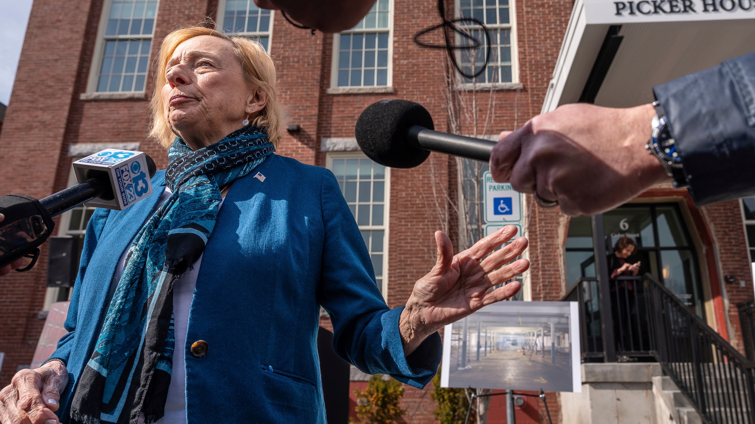 Maine Gov. Janet Mills speaks to the press Wednesday after a dedication of the Picker House Lofts in the Continental Mill in Lewiston. (Andree Kehn/Sun Journal via AP)