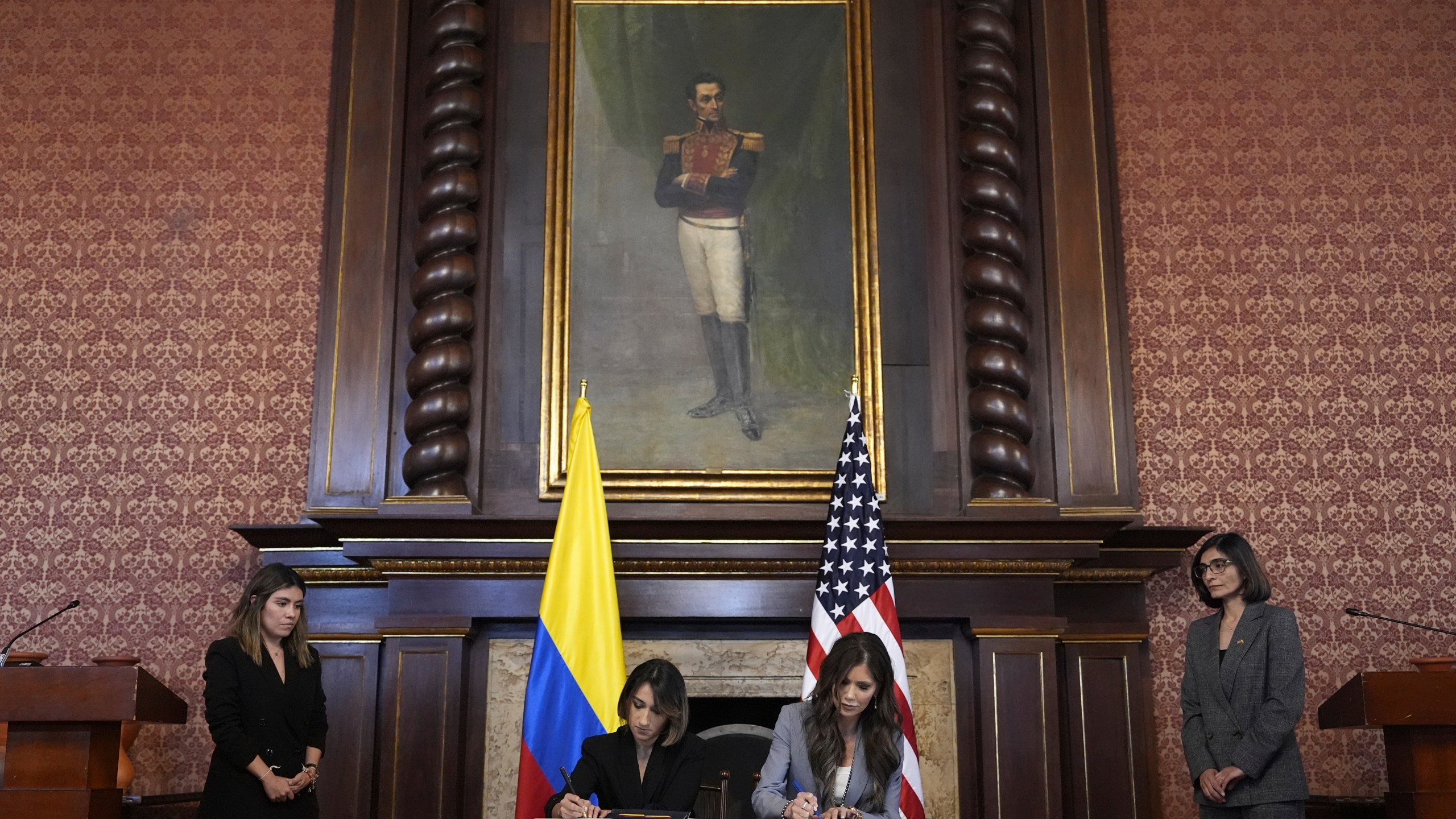 U.S. Homeland Security Secretary Kristi Noem, at table on right, and Colombian Foreign Minister Laura Sarabia sign a Biometric Data Sharing Program Letter of Intent in Bogota, Colombia, Thursday, March 27, 2025. (AP Photo/Alex Brandon)