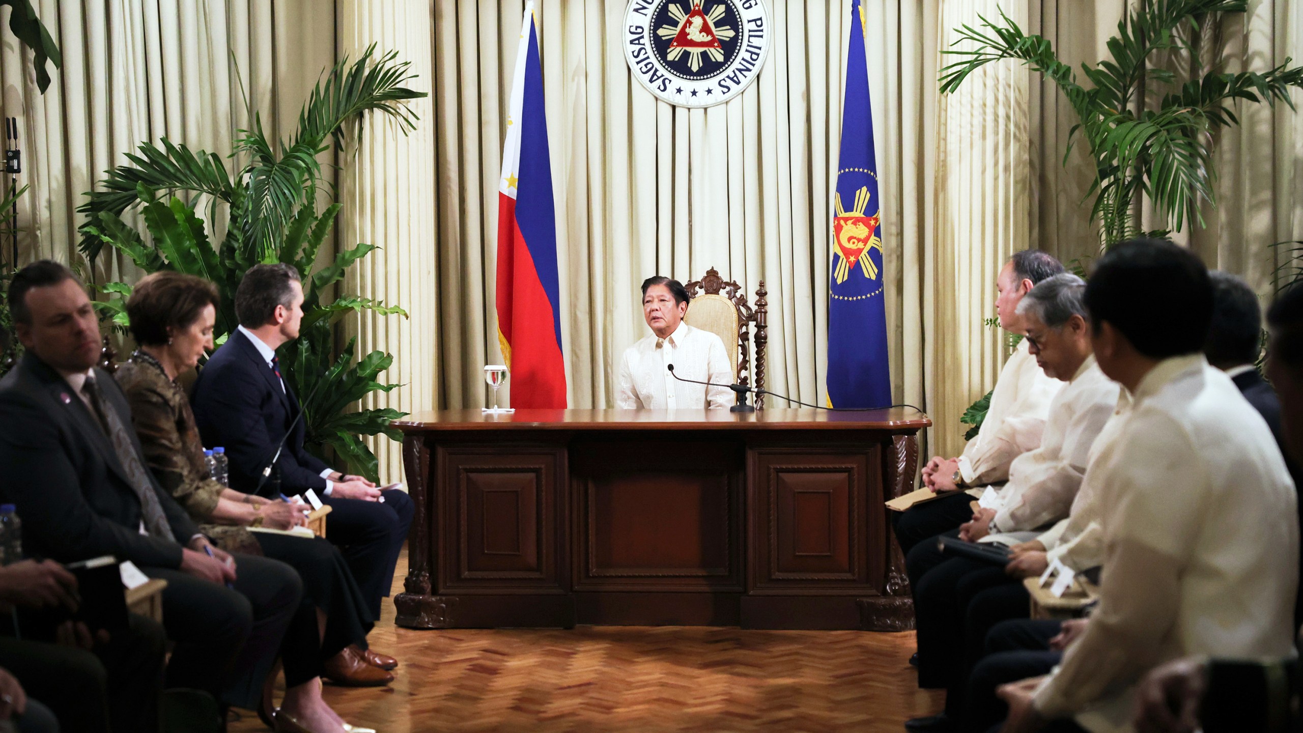 Philippine President Ferdinand Marcos Jr., center, meets with U.S. Defense Secretary Pete Hegseth, third left, at the Malacanang presidential palace in Manila, Philippines, Friday, March 28, 2025. (AP Photo/Basilio Sepe, Pool)