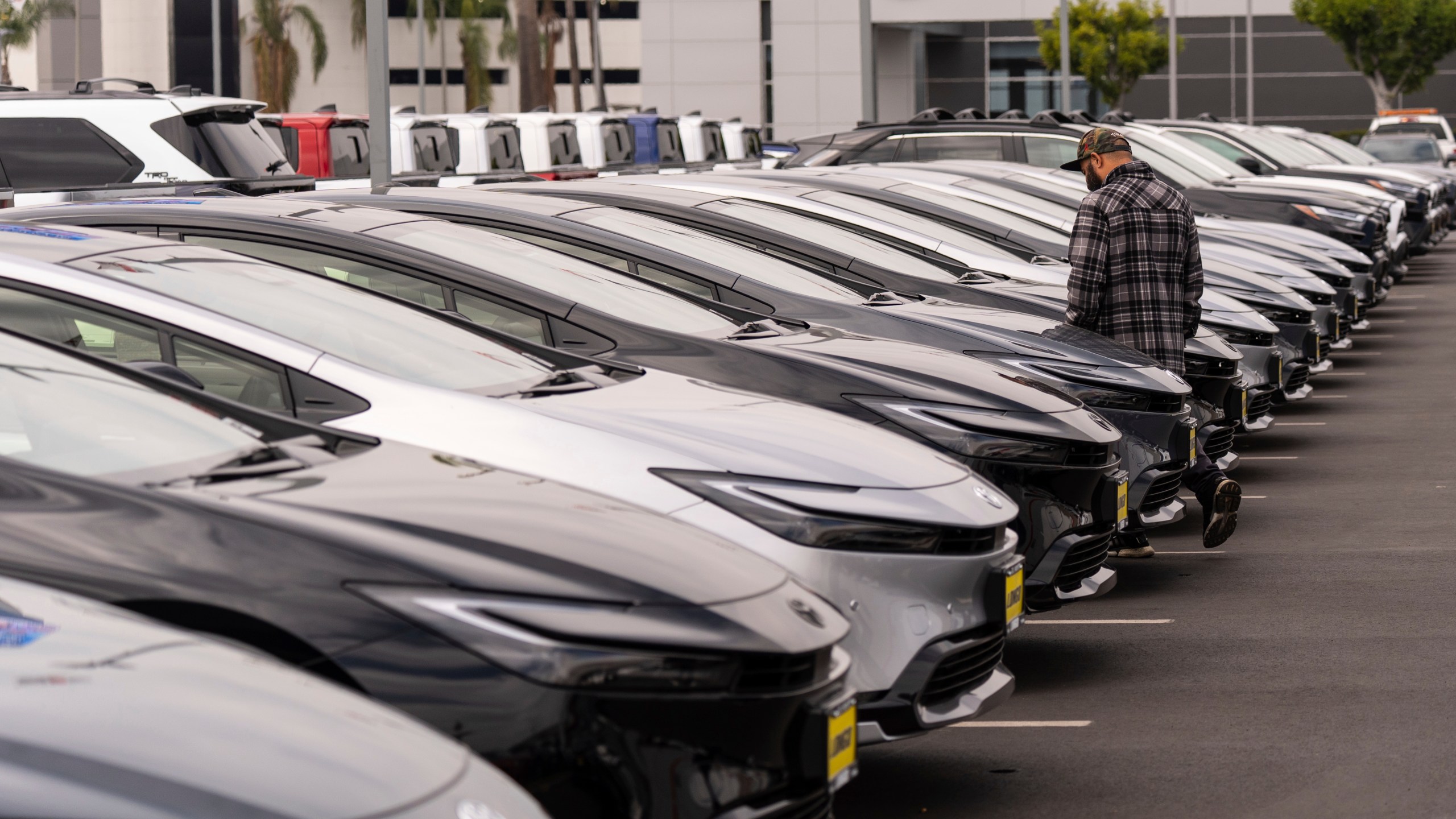 A person looks at a new vehicle at a Toyota dealership in El Monte, Calif., Thursday, March 27, 2025. (AP Photo/Jae C. Hong)