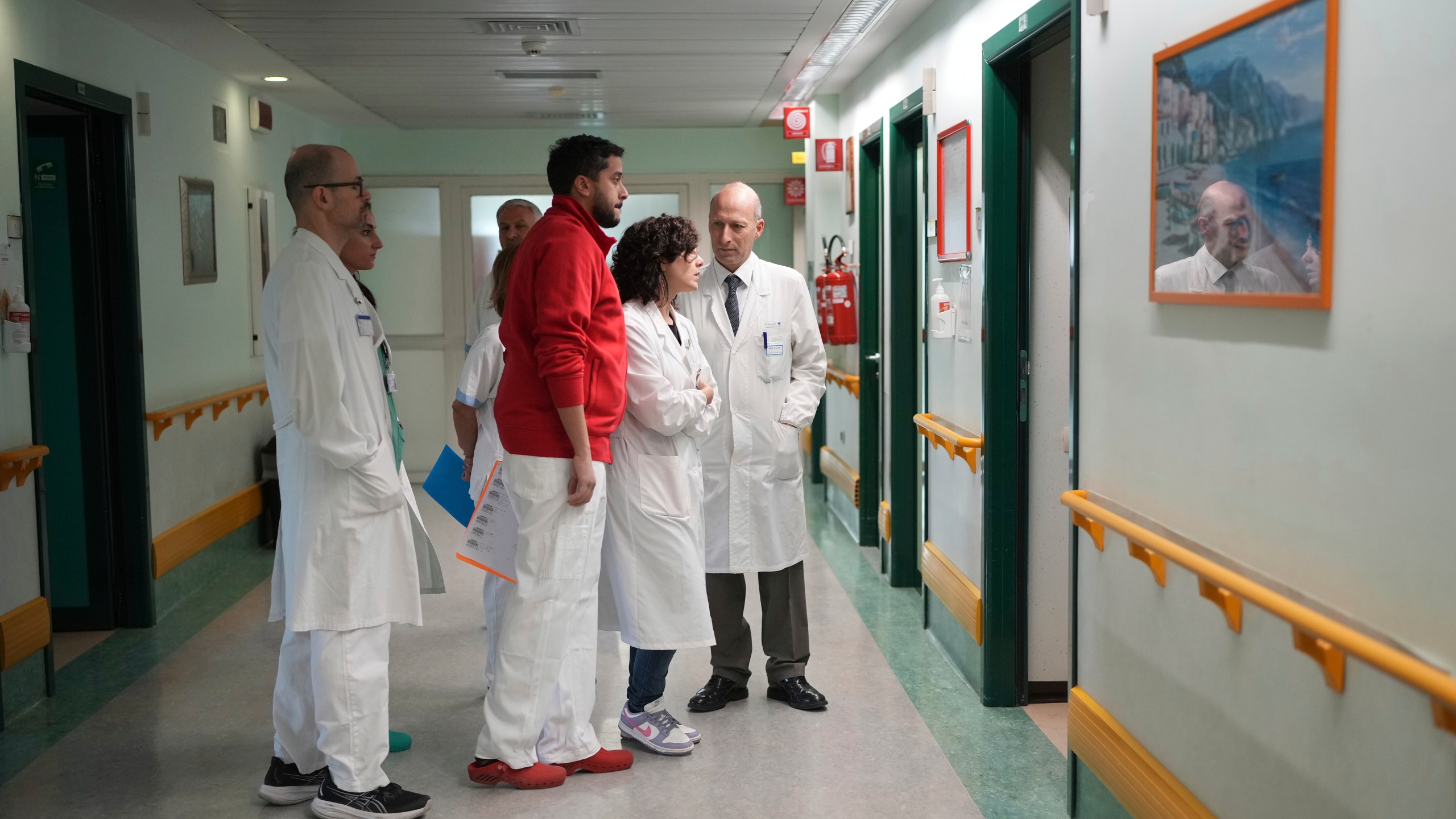 Professor and surgeon Sergio Alfieri, right, second from left, who headed the team who treated Pope Francis during his hospitalisation, talks with his team before an interview with the Associated Press at the Gemelli polyclinic hospital in Rome, Saturday, March 29, 2025. (AP Photo/Alessandra Tarantino)