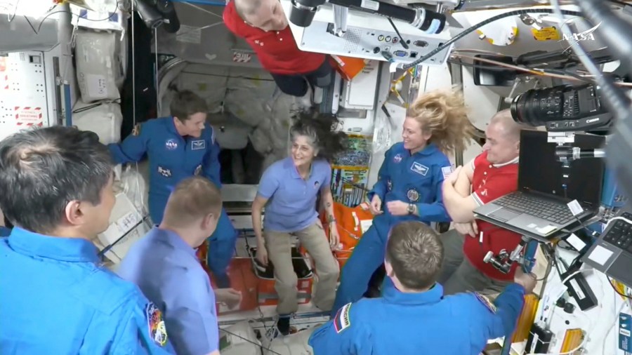 Astronauts greet each other at space station