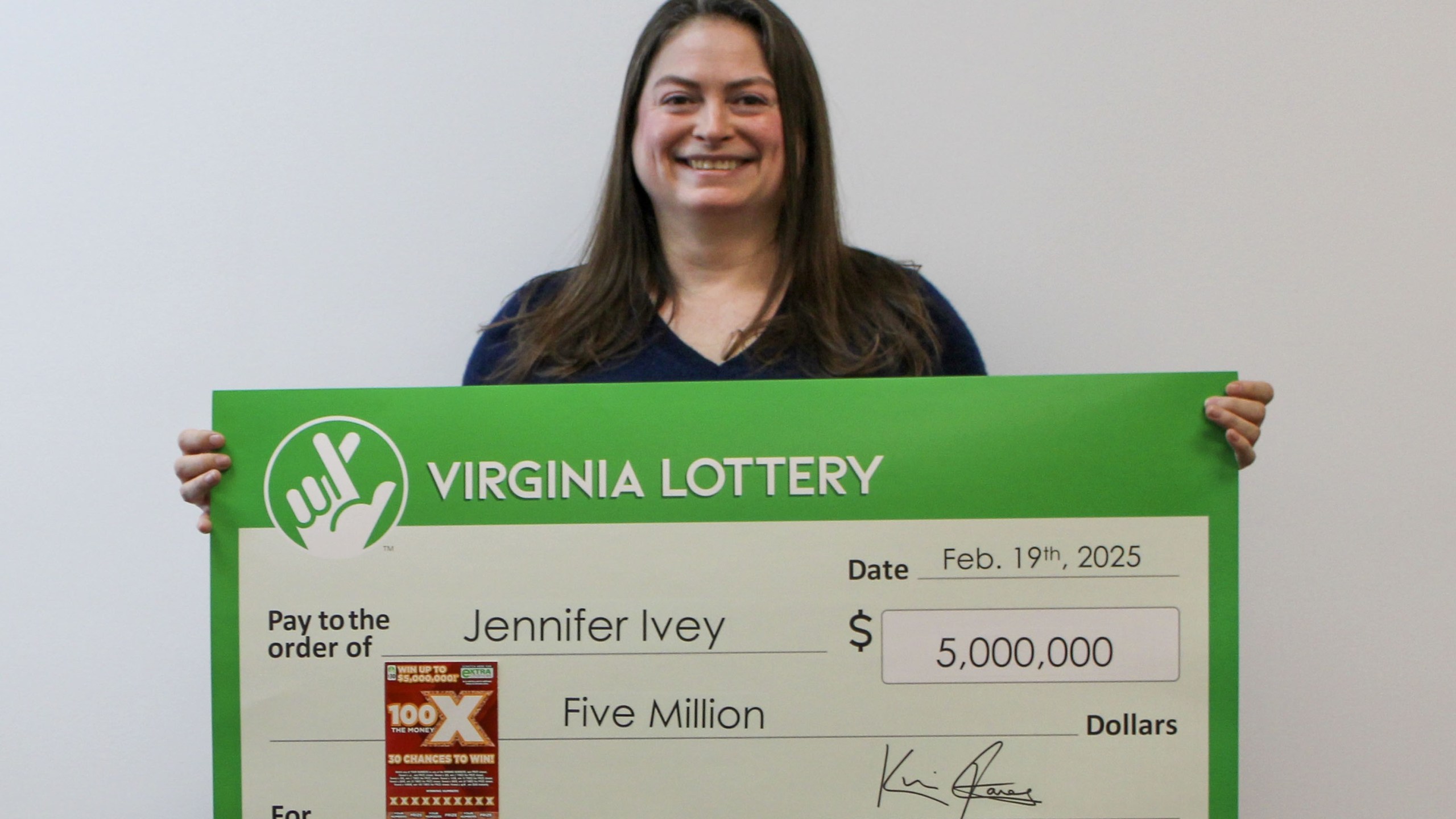 Jennifer Ivey of Chantilly, Va. poses with a big check after winning $5 million on a lottery scratcher. (Virginia Lottery)