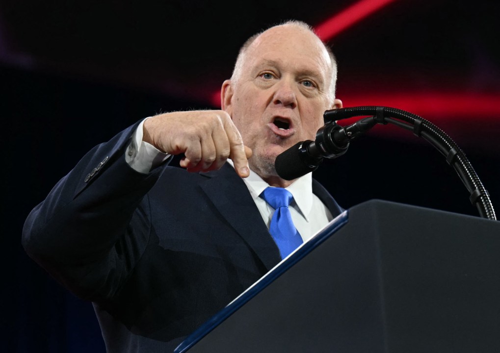 Tom Homan gestures at a lectern