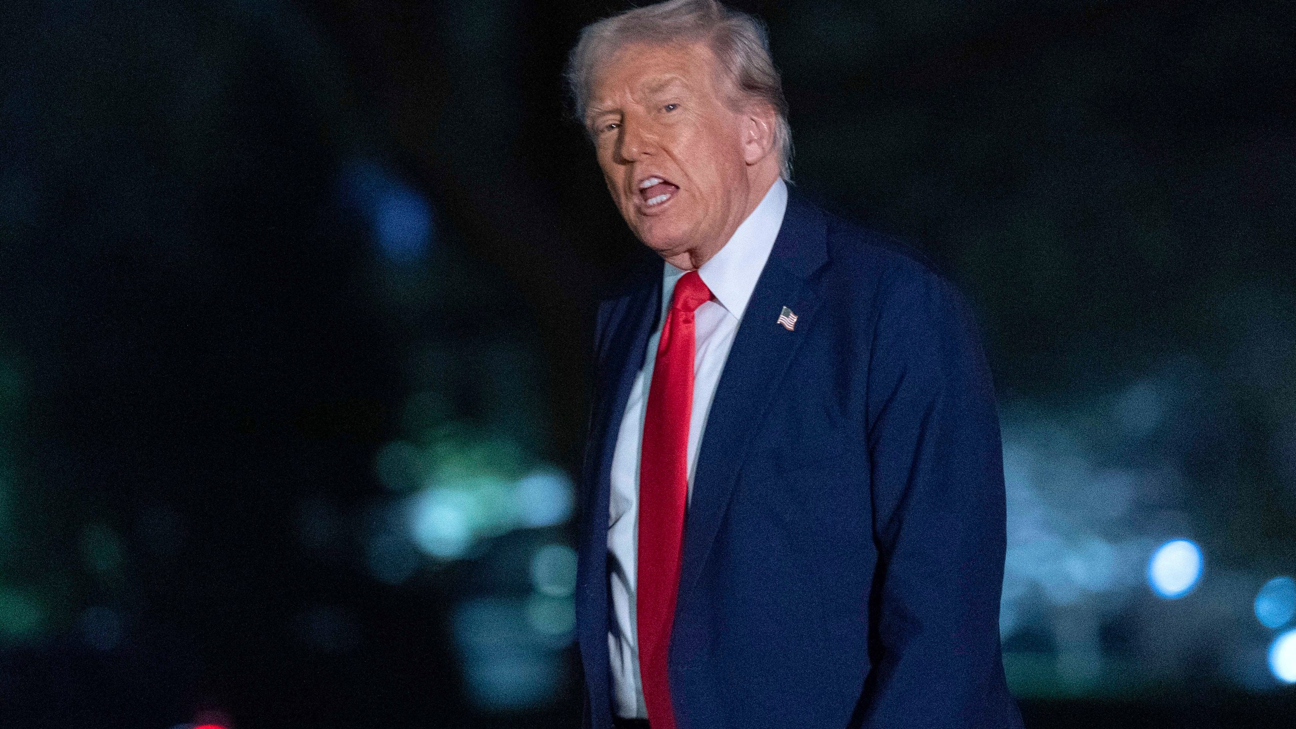 President Donald Trump talks to reporters as he walks on the South Lawn of the White House, in Washington, Sunday, March 30, 2025. (AP Photo/Jose Luis Magana)