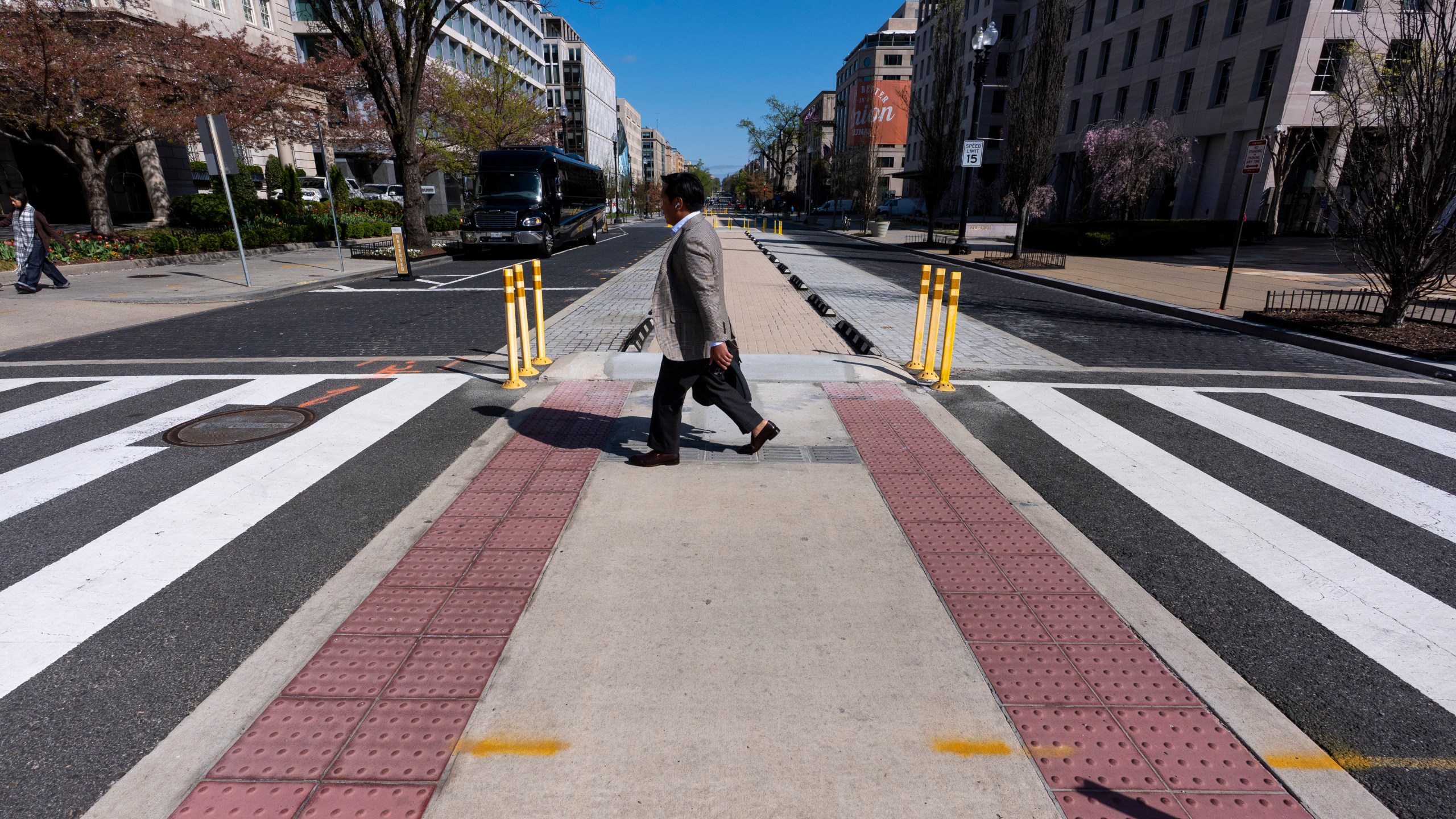 A man walks across 16th Street NW, after Black Lives Matter Plaza has been re-done eliminating the tribute, Tuesday, April 1, 2025, in Washington. (AP Photo/Alex Brandon)