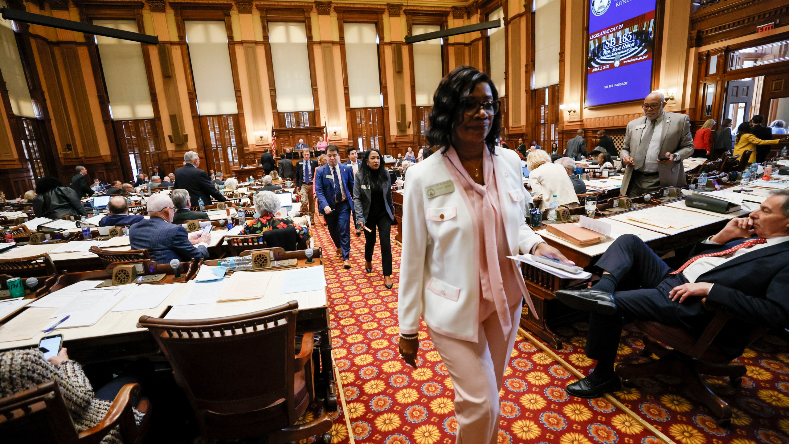 Georgia House Democrats, led by House Minority Leader Carolyn Hugley, D-Columbus, walk out of the House Chamber as Senate Bill 185, which would outlaw spending on gender affirming care for transgender prisoners, was introduced at the state Capitol, Wednesday, April 2, 2025, in Atlanta. (Miguel Martinez/Atlanta Journal-Constitution via AP)