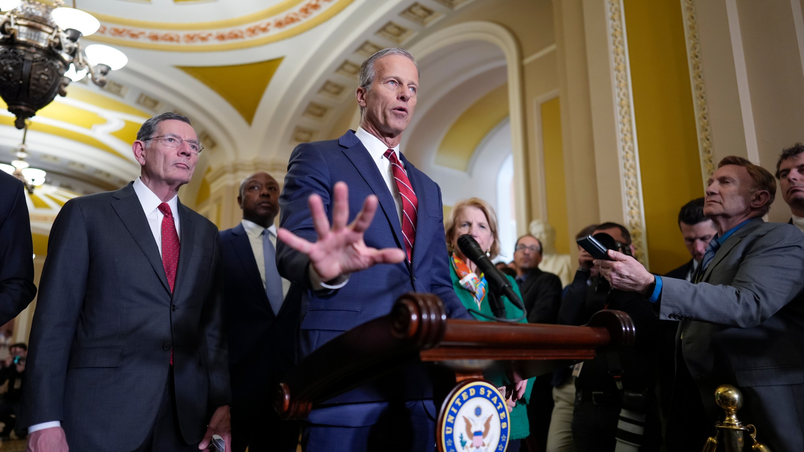 Senate Majority Leader John Thune, R-S.D., joined by Sen. John Barrasso, R-Wyo., the GOP whip, left, talks to reporters at the Capitol, in Washington, Tuesday, April 1, 2025. (AP Photo/J. Scott Applewhite)