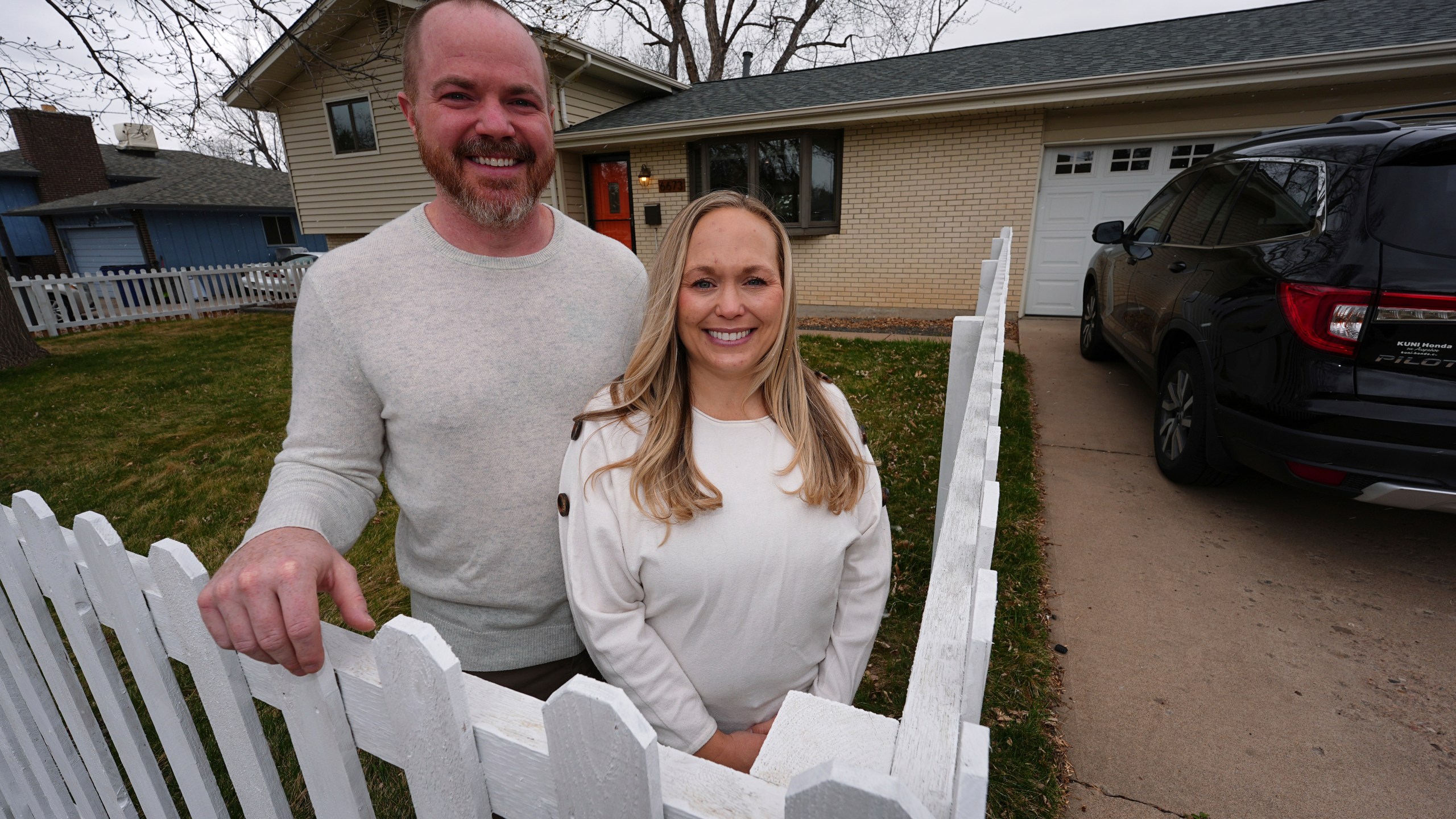 Ryan Vasko and his wife are shown outside the home they just bought after moving from Oregon Thursday, April 3, 2025, in Littleton, Colo. (AP Photo/David Zalubowski)