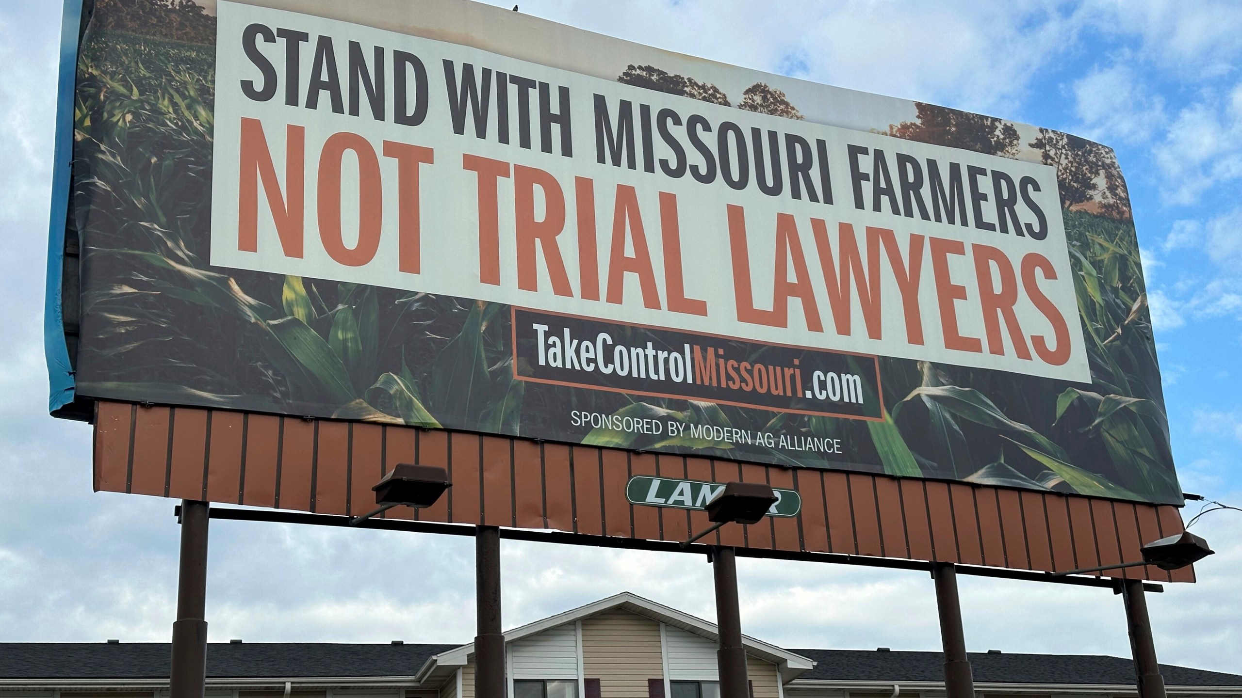 FILE - A billboard supporting legislation that would provide legal protection to manufacturers of pesticides such as Bayer's popular weedkiller Roundup, is shown in Jefferson City, Mo., May 13, 2024. (AP Photo/David A. Lieb, File)
