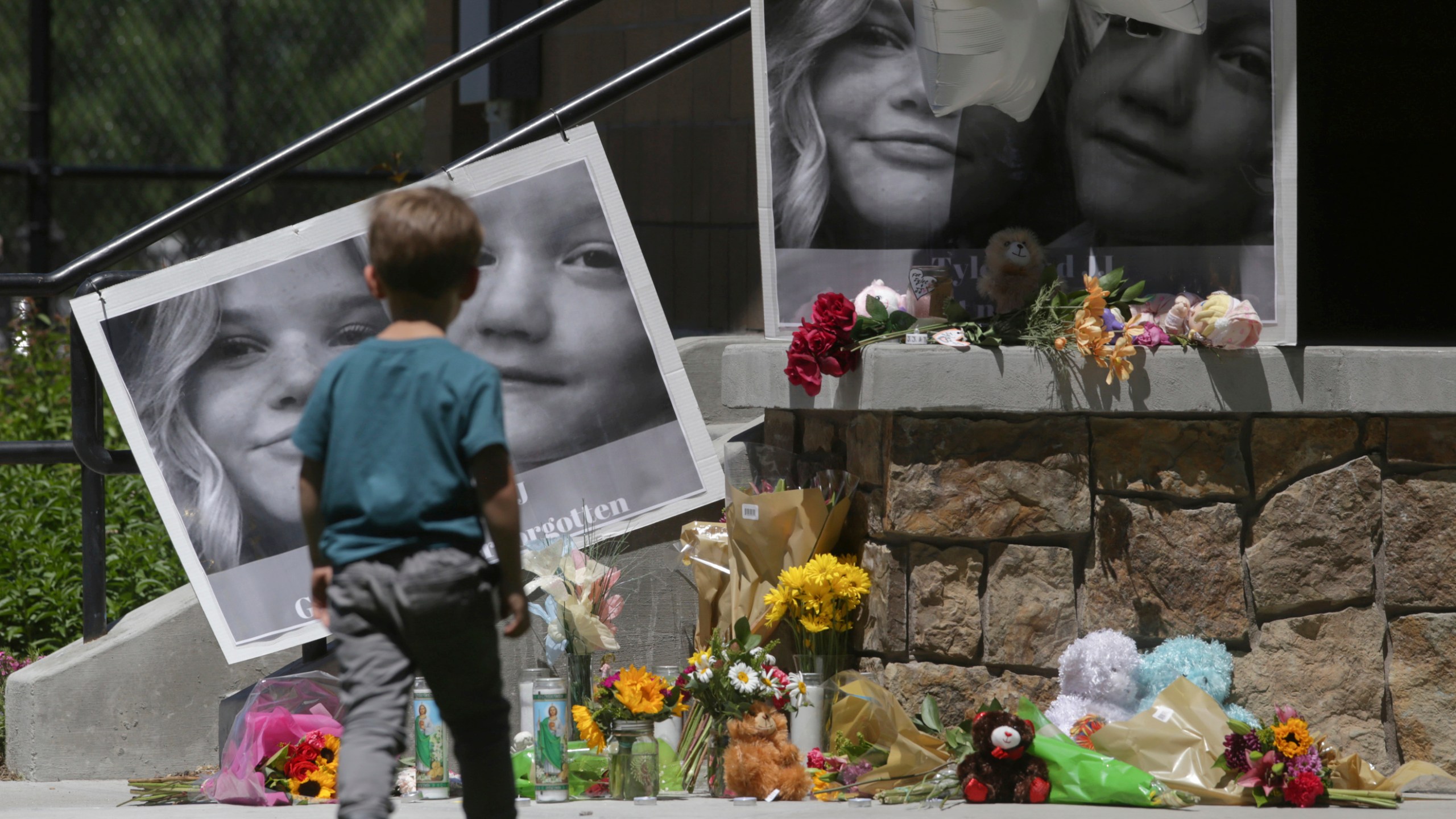 FILE - A boy looks at a memorial for Tylee Ryan and Joshua "JJ" Vallow in Rexburg, Idaho, on June 11, 2020. (John Roark/The Idaho Post-Register via AP, File)