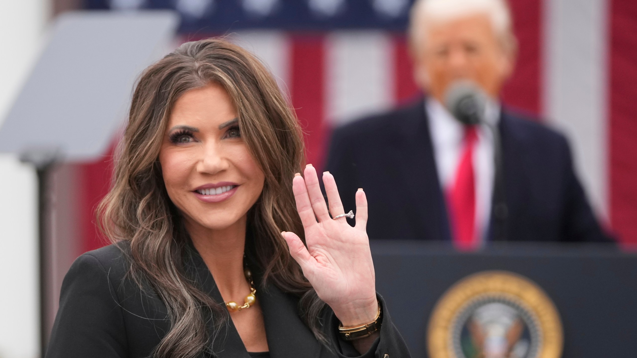 Homeland Security Secretary Kristi Noem is recognized as President Donald Trump speaks during an event to announce new tariffs in the Rose Garden at the White House, Wednesday, April 2, 2025, in Washington. (AP Photo/Mark Schiefelbein)