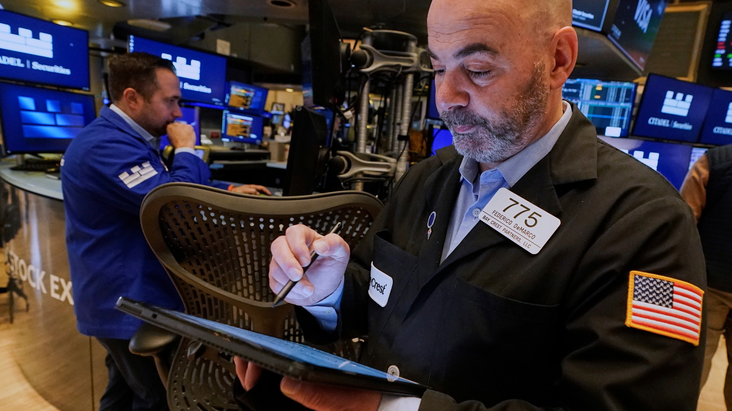 Trader Fred Demarco, right, works on the floor of the New York Stock Exchange, Thursday, April 10, 2025. (AP Photo/Richard Drew)