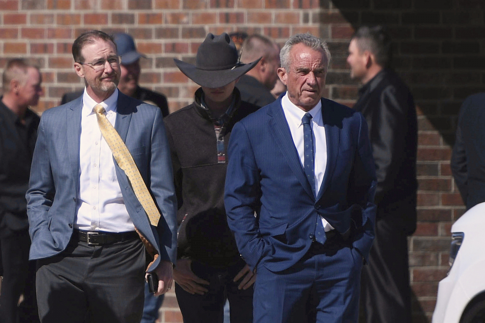 FILE - Health and Human Services Secretary Robert F. Kennedy Jr., right, arrives at Reinlander Mennonite Church in Seminole, Texas, on Sunday, April 6, 2025, after a second measles-related death in the state. (AP Photo/Annie Rice, File)