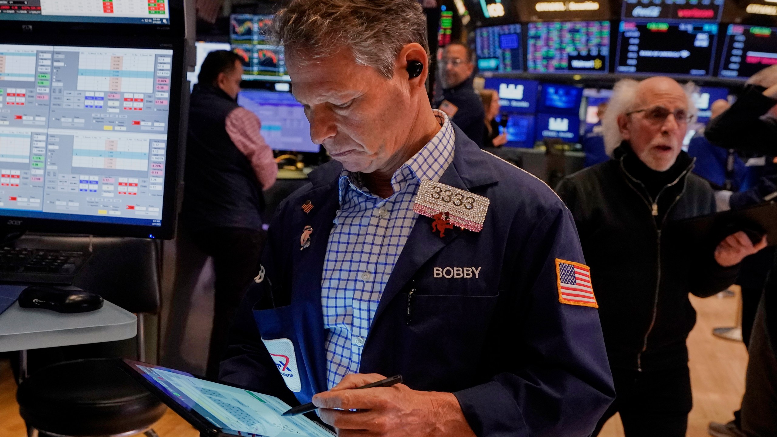 Trader Robert Charmak, left, works on the floor of the New York Stock Exchange, Friday, April 11, 2025. (AP Photo/Richard Drew)