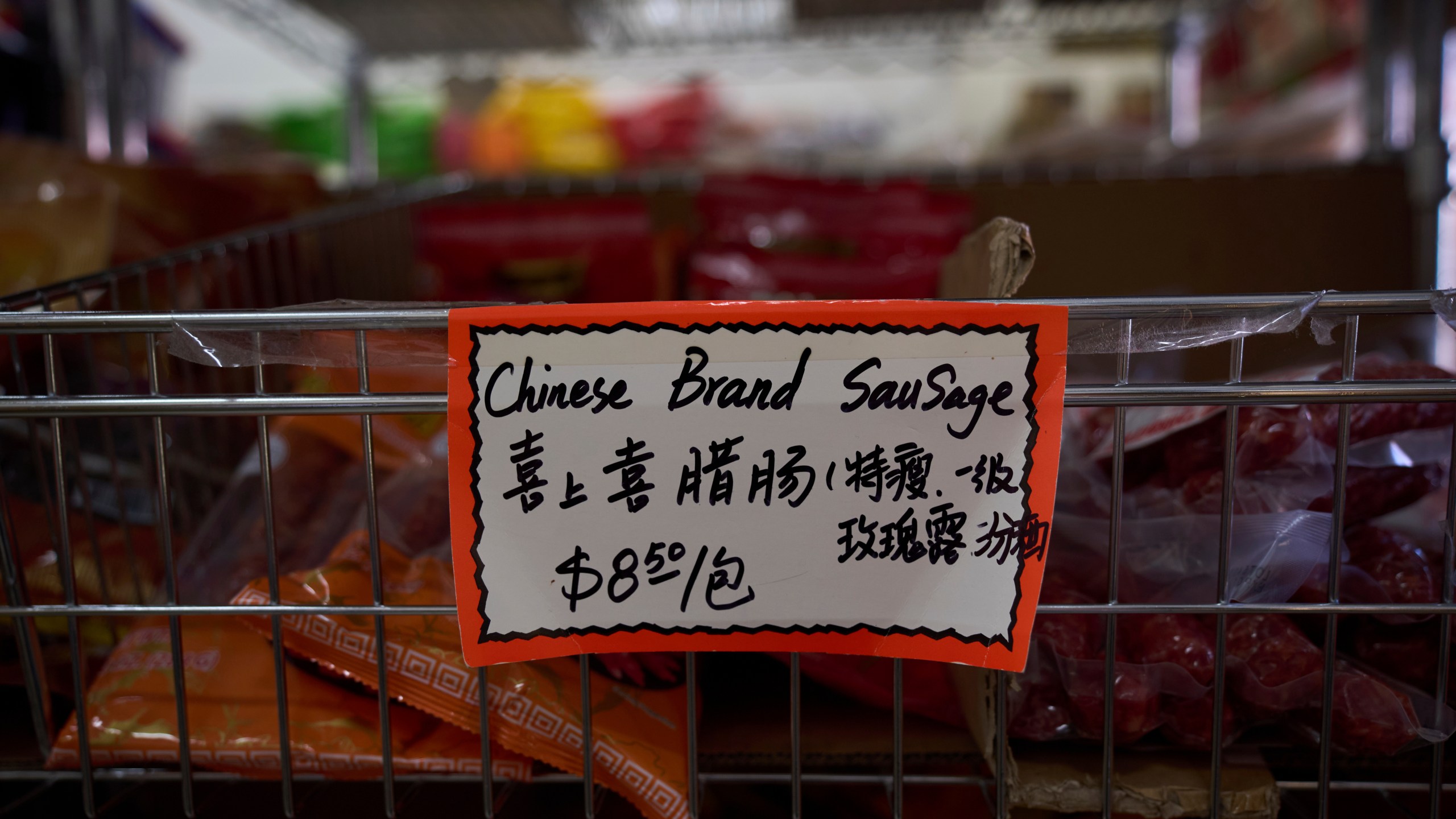 A handwritten price tag for sausage imported from China is seen at a grocery market in the Chinatown neighborhood of Los Angeles, Friday, April 11, 2025. (AP Photo/Jae C. Hong)