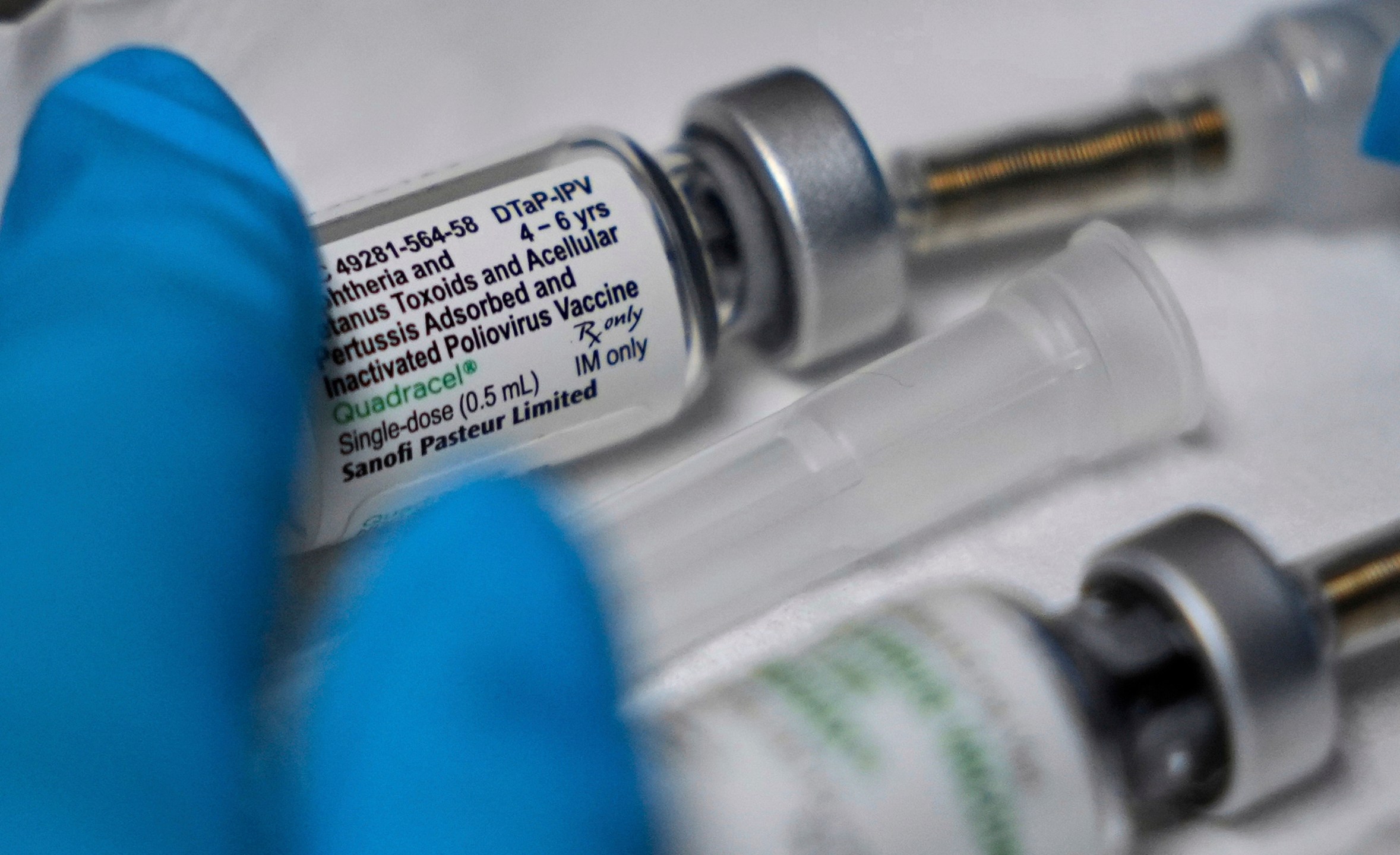A vaccination that includes a polio dose is prepared for a child at the Dallas County Health and Human Services immunization clinic in Dallas, Friday, April 4, 2025. (AP Photo/LM Otero)