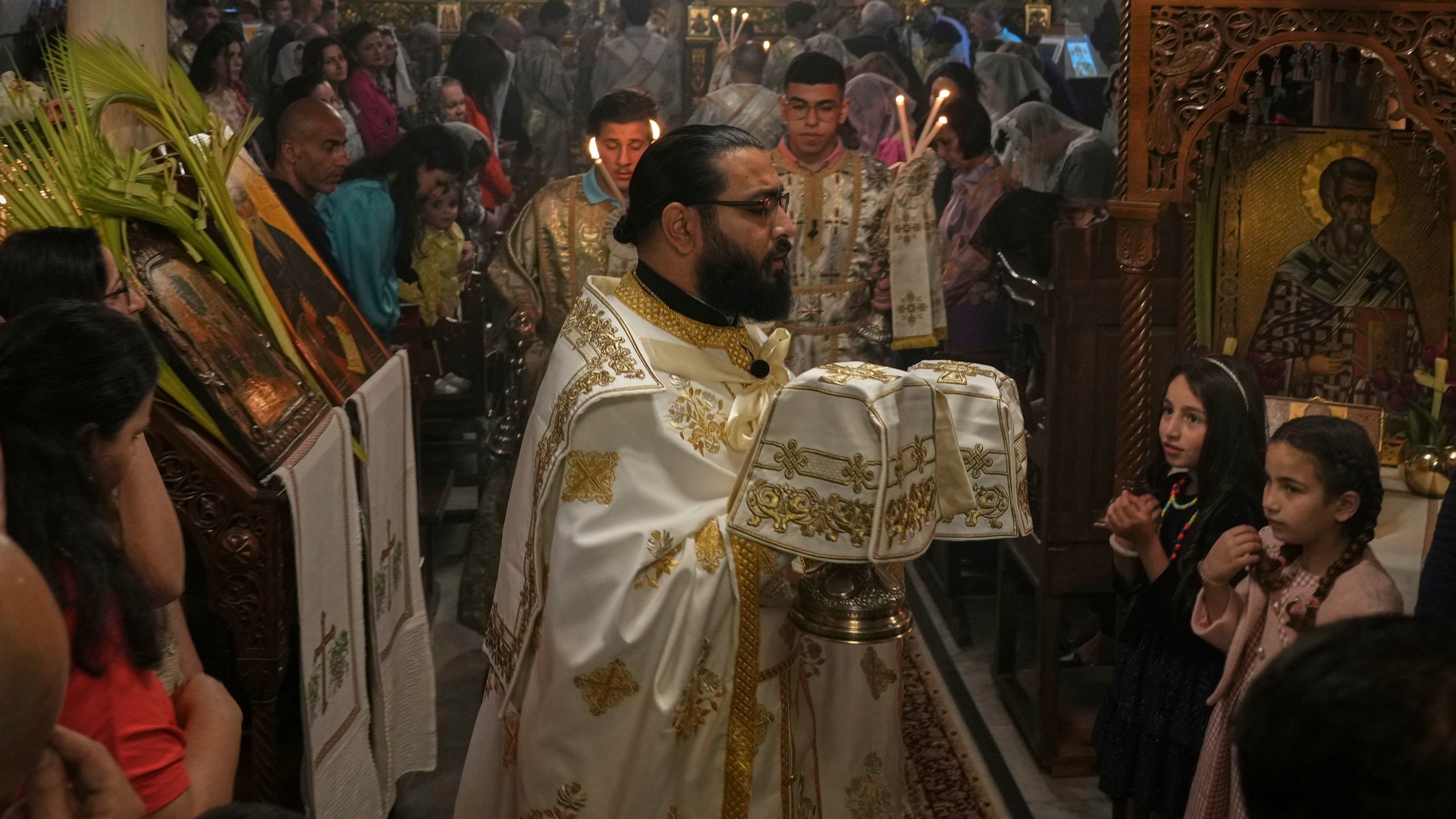 Palestinian Christians attend a Palm Sunday mass at the Greek Orthodox Church of Saint Porphyrius in Gaza City, Sunday, April 13, 2025. (AP Photo/Jehad Alshrafi)